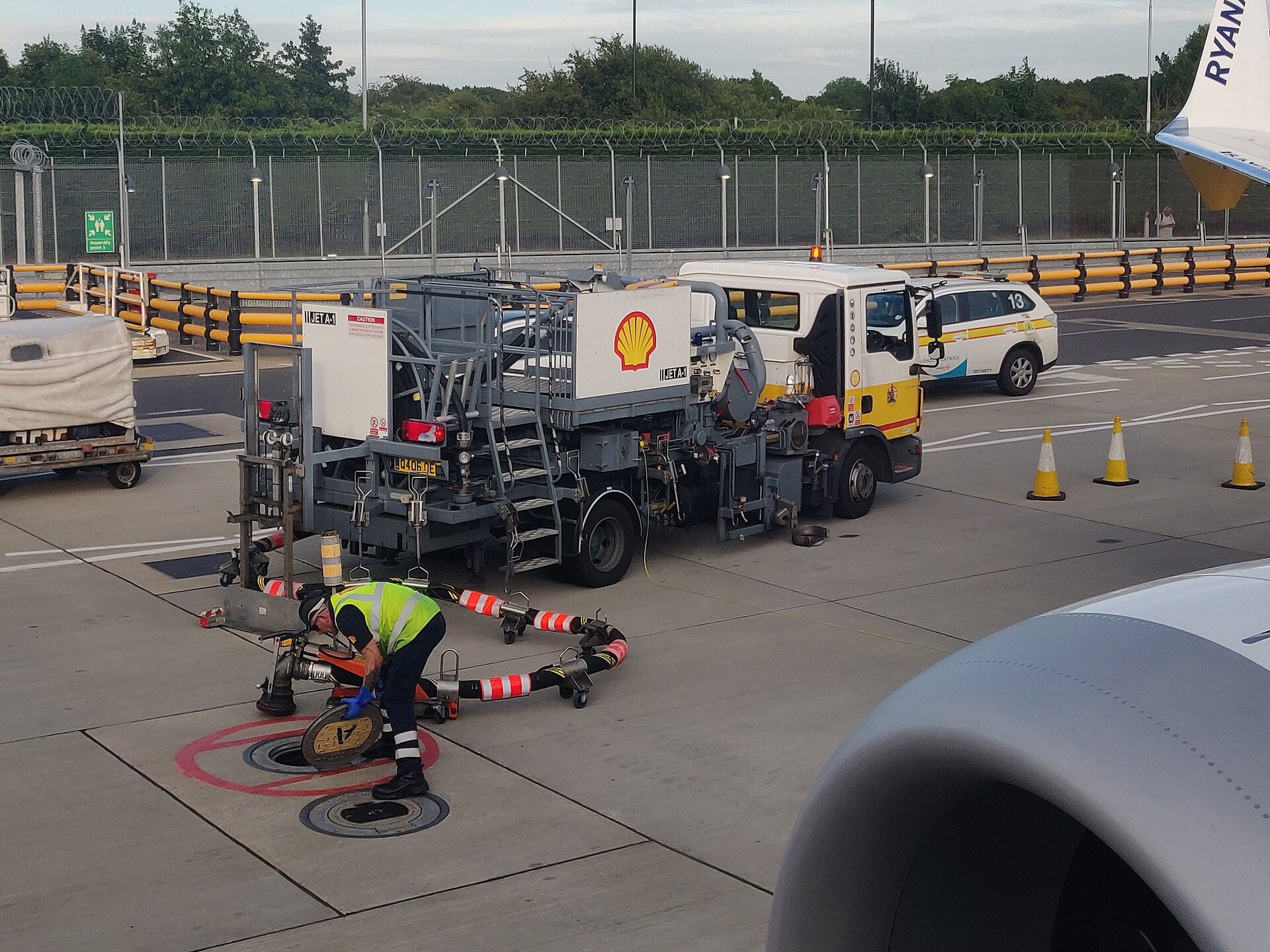 An aircraft being refuelled on an airport apron