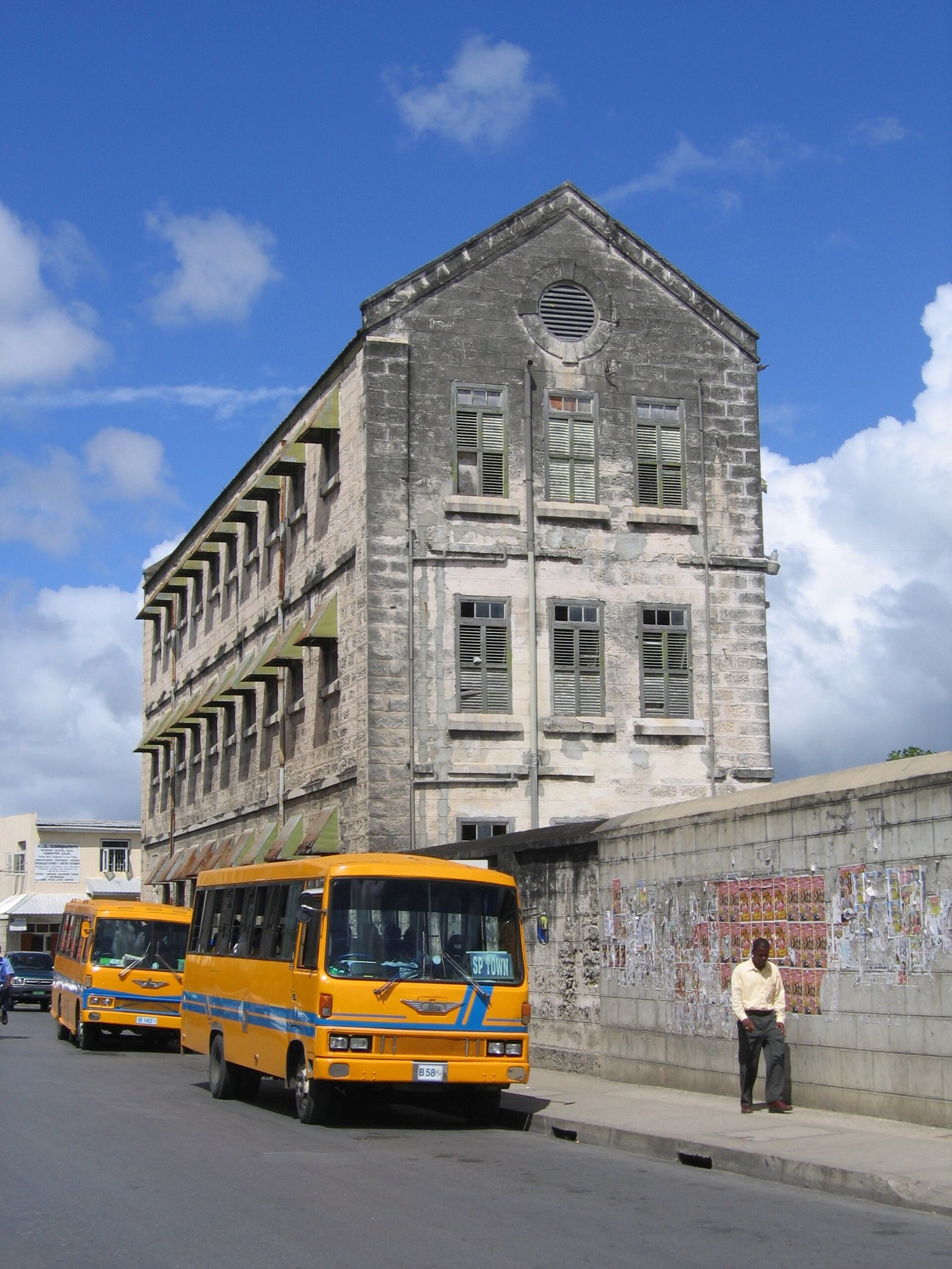 Yellow privately run minibuses on a street in Bridgetown, Barbados