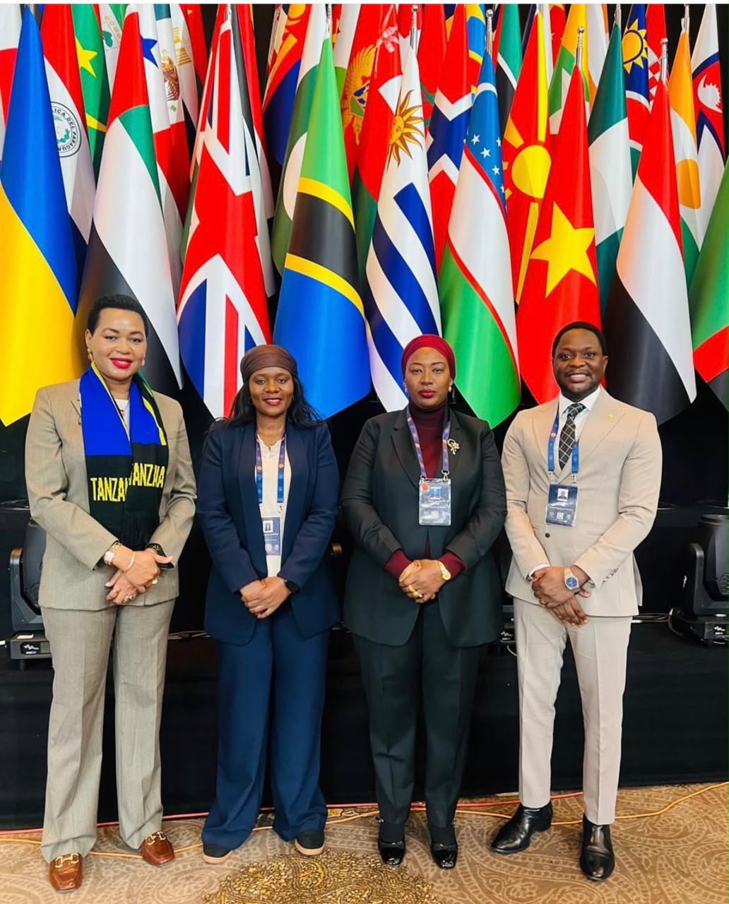 Tanzania's delegation to a previous IPU General Assembly, pictured with member flags