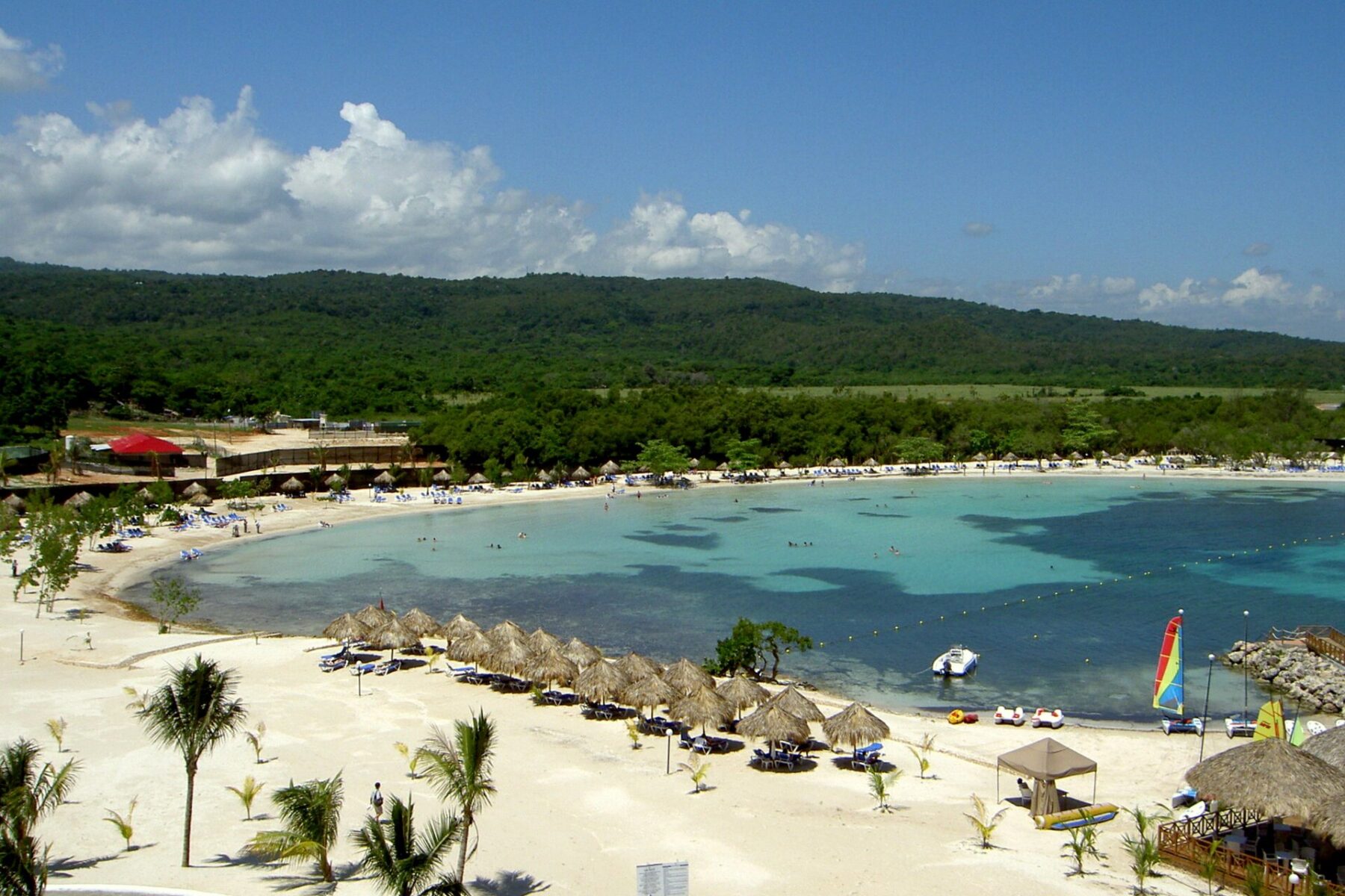 A resort beach with palm trees and turquoise water on the north coast of Jamaica