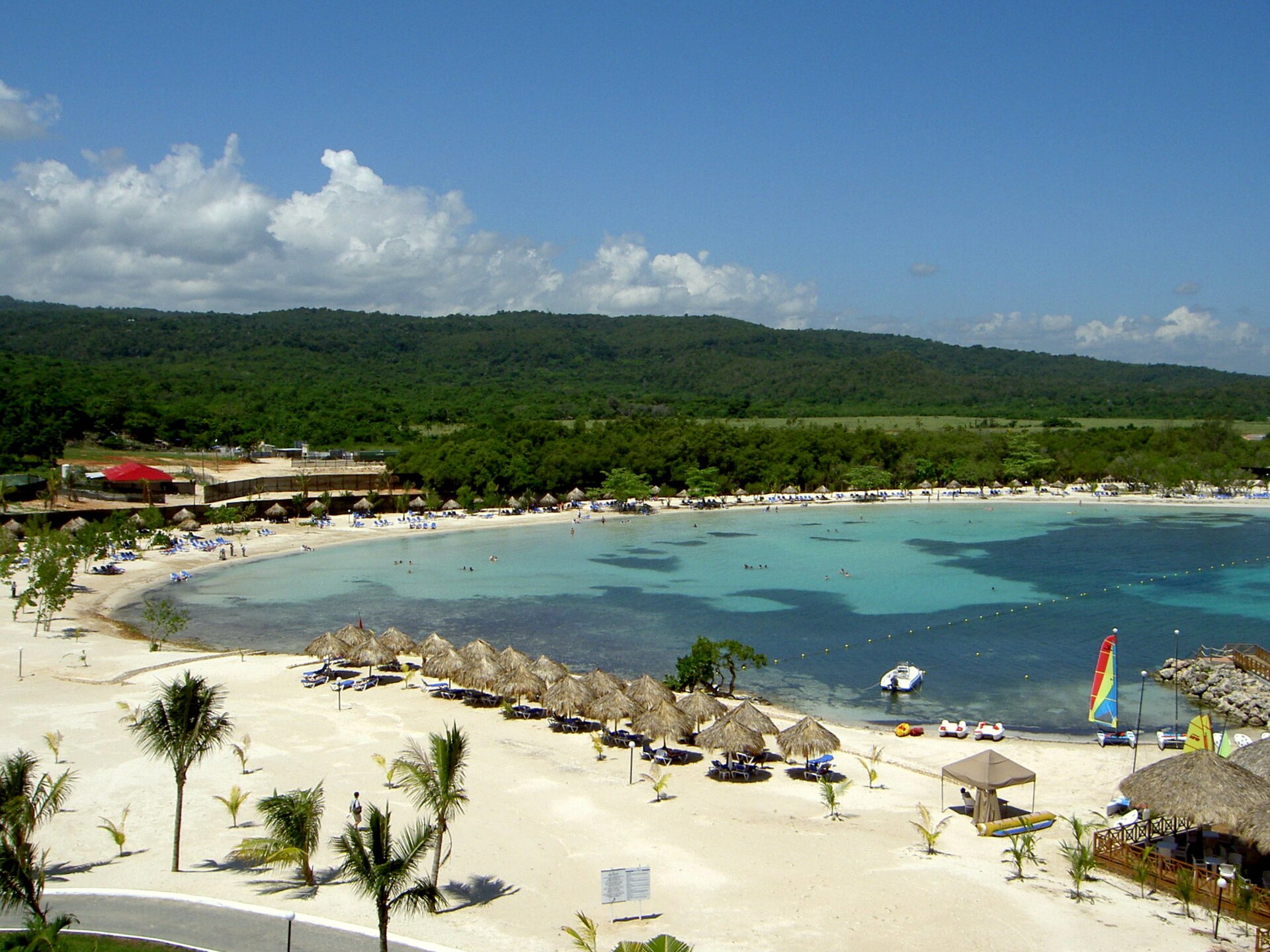 A resort beach with palm trees and turquoise water on the north coast of Jamaica