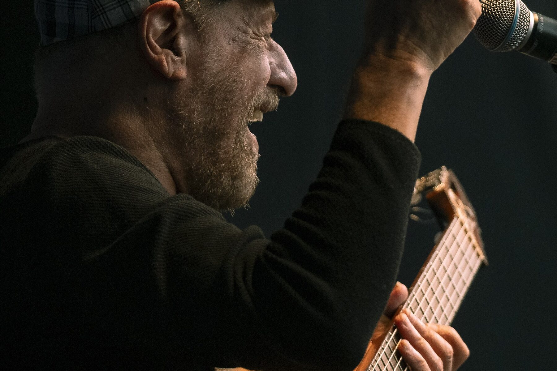 The Brazilian singer and guitarist Joao Bosco performing on stage with his guitar