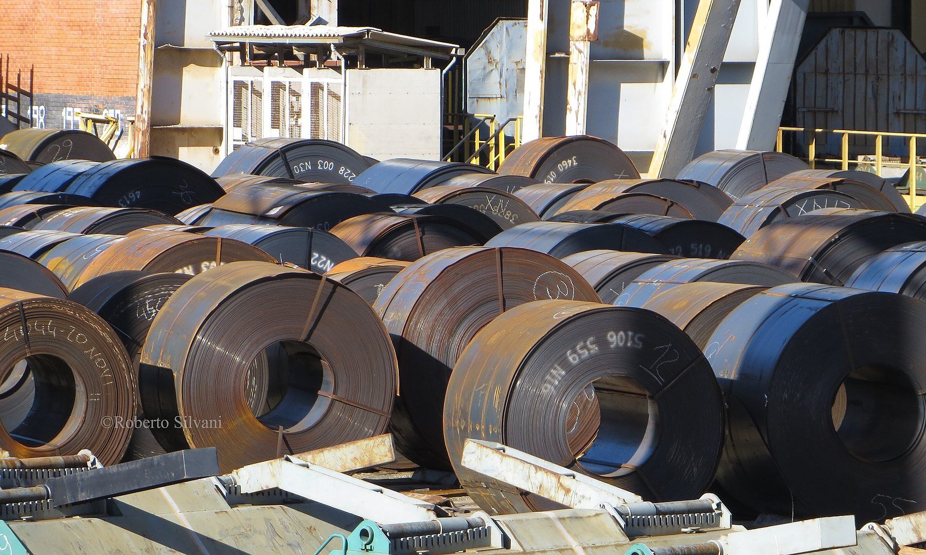 Rows of hot-rolled steel coils stacked in an industrial yard