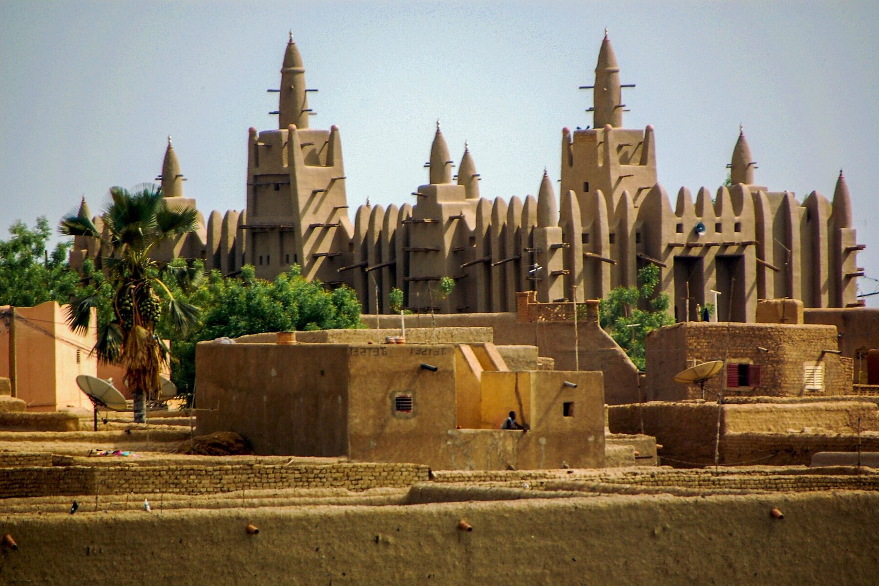 Mali explained: the Great Mosque of Djenné rising above the mud-brick roofs of the town