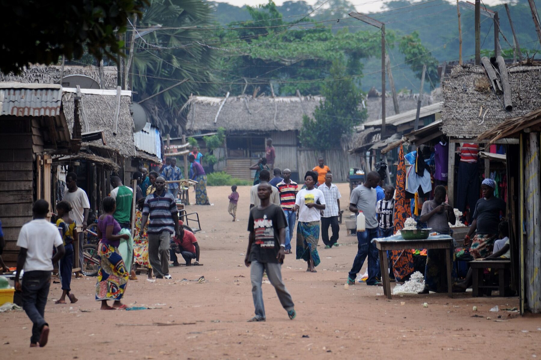 Busy African village street with people and market stalls