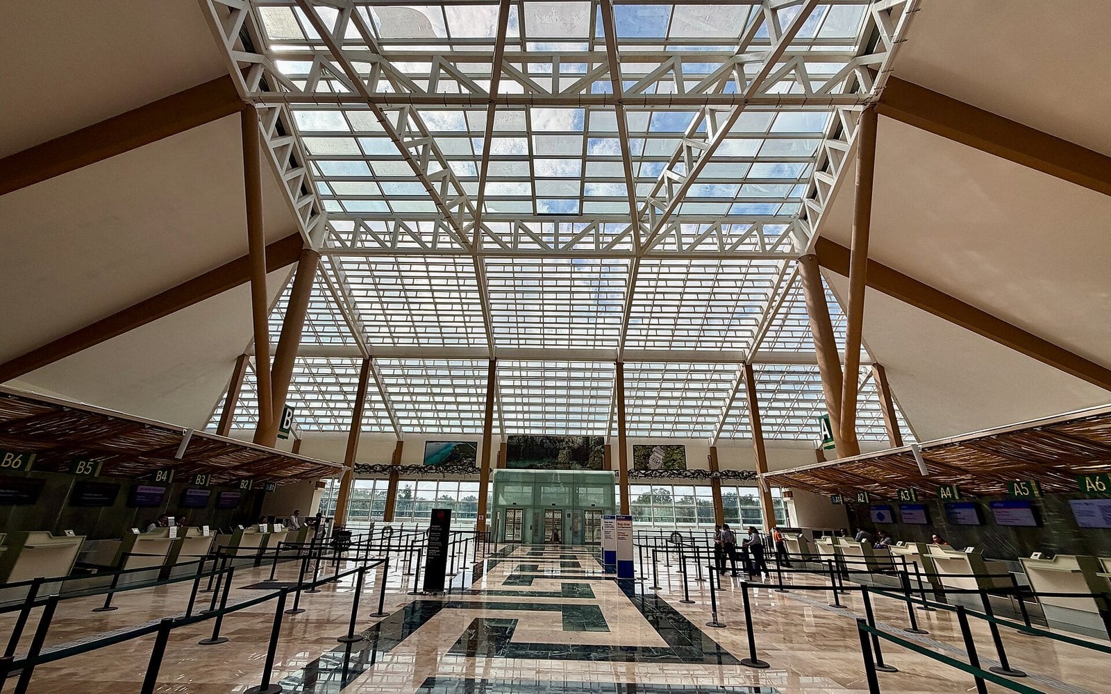  the check-in hall of Tulum International Airport in Mexico, with a timber and glass roof