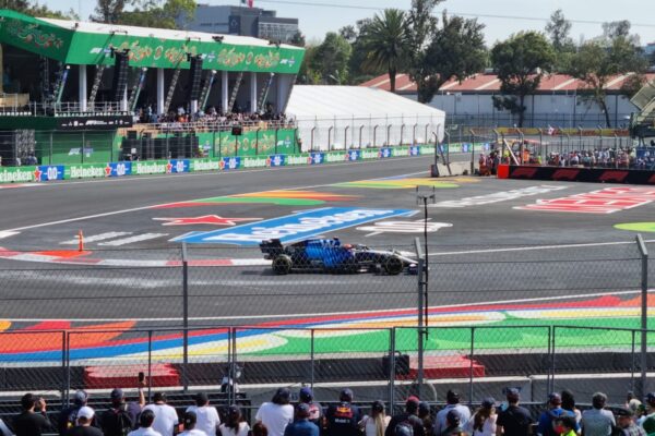 A Formula 1 car passes a packed grandstand at the Autódromo Hermanos Rodríguez in Mexico City
