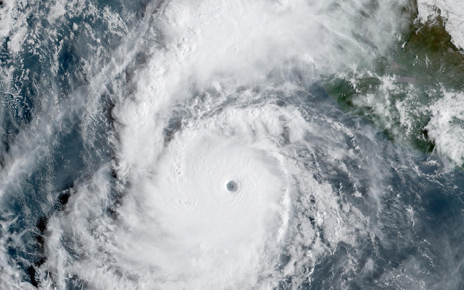 Hurricane Polo seen from the GOES-West weather satellite over the Pacific off western Mexico, with a clear eye at its centre