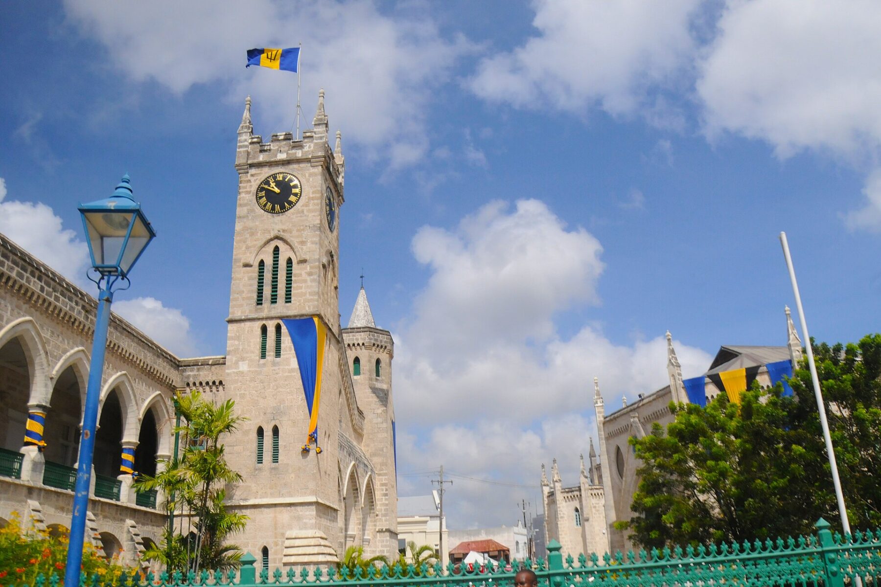 Moving to Barbados 2026 — the Parliament Buildings and clock tower in Bridgetown under the national flag