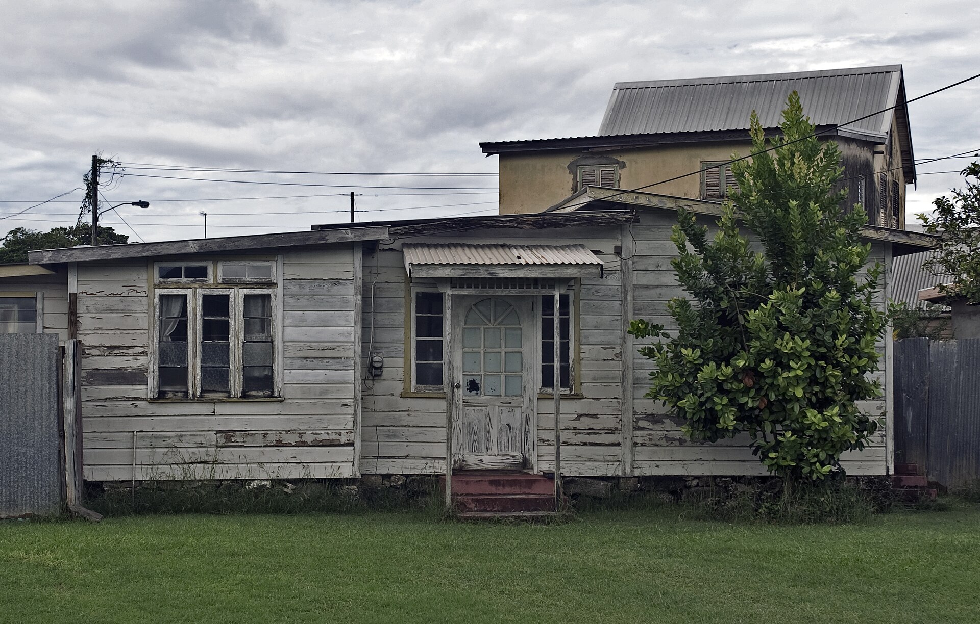 Moving to Barbados — a traditional timber house with a corrugated roof