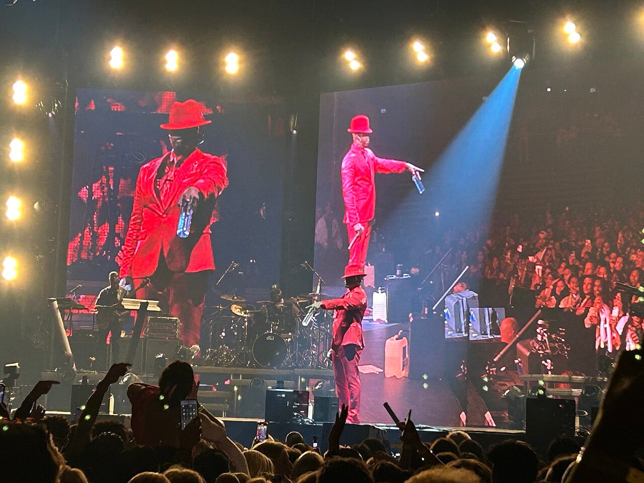 Ne-Yo in a red suit and hat performing in an arena, ahead of the Ne-Yo South Africa shows