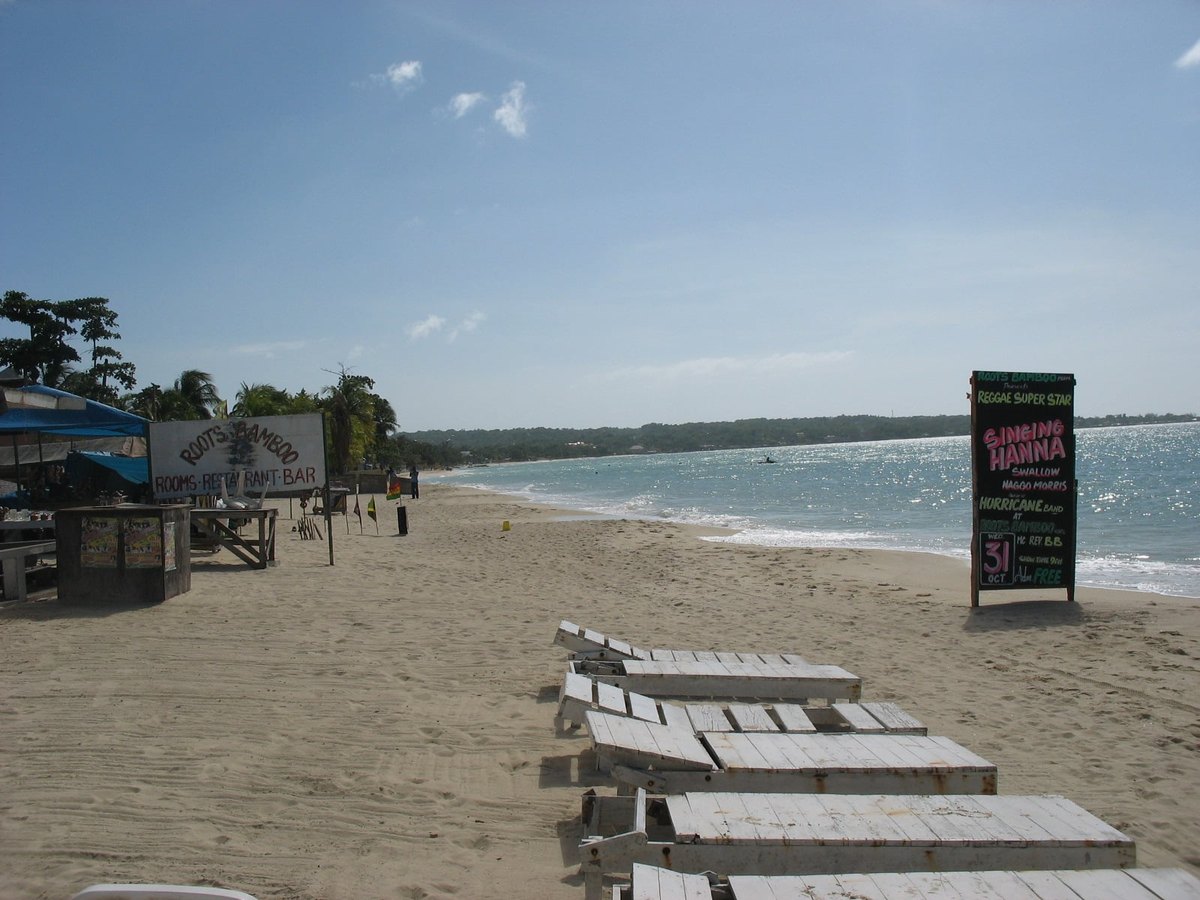 Loungers on the sand of Negril's Seven Mile Beach in western Jamaica