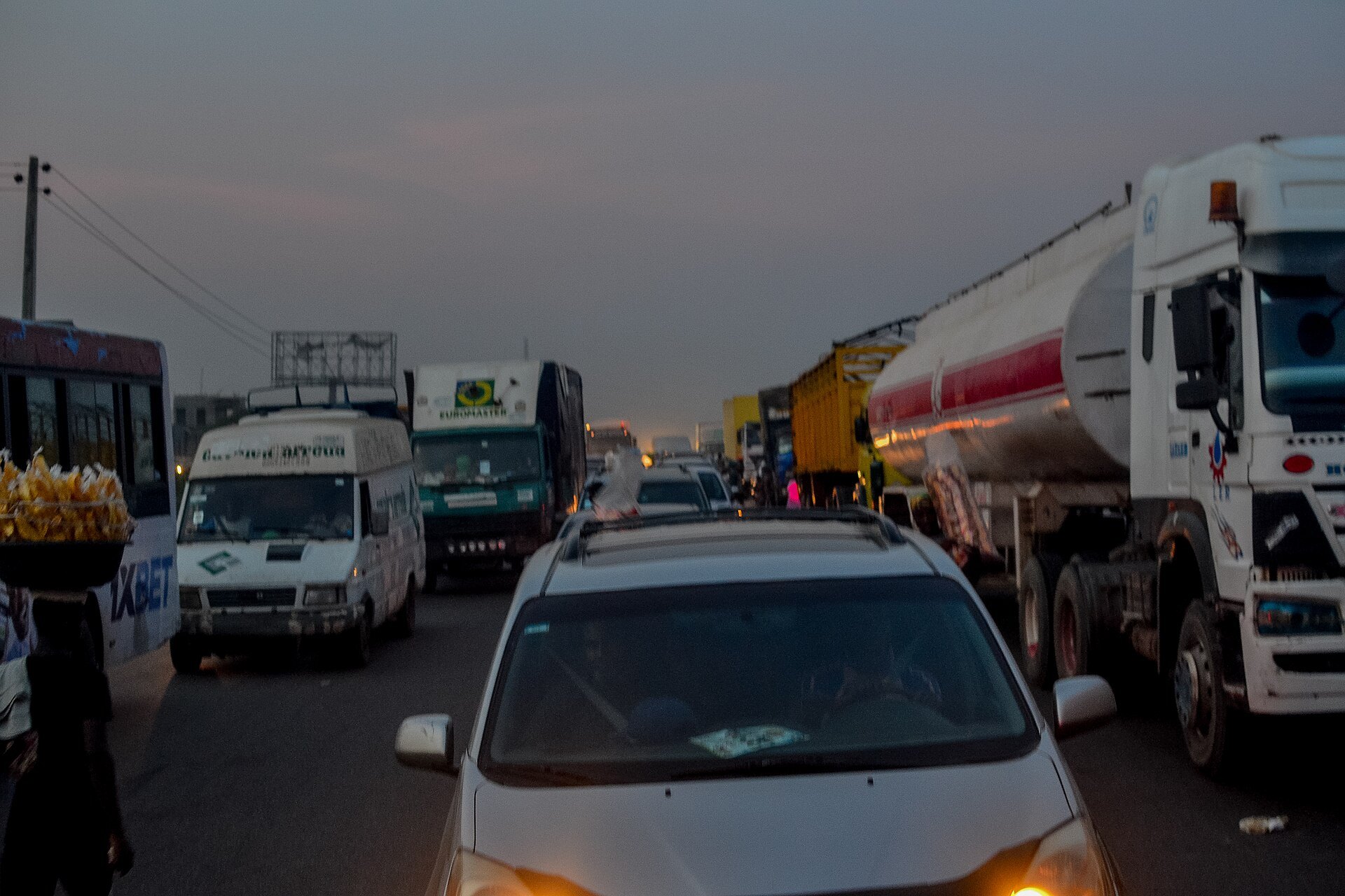 Heavy traffic of cars, vans and fuel tankers at dusk on the Lagos-Ibadan Expressway in Nigeria