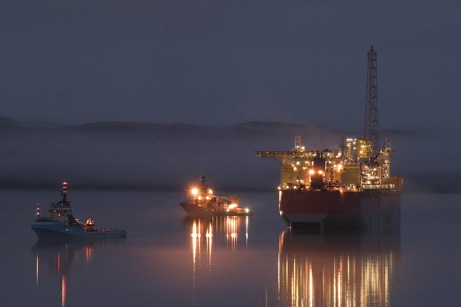 The SeaRose FPSO with offshore support vessels at night.