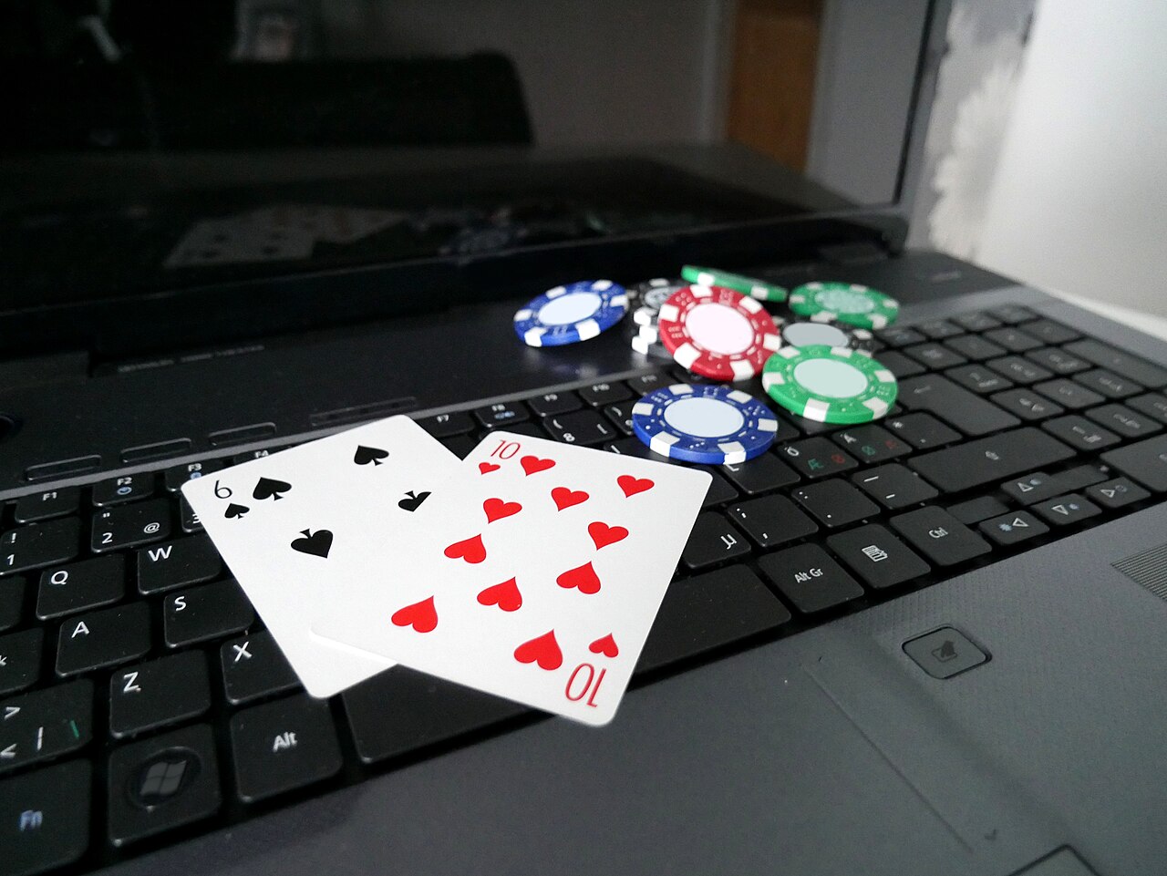 Online gaming: laptop with poker cards and poker chips