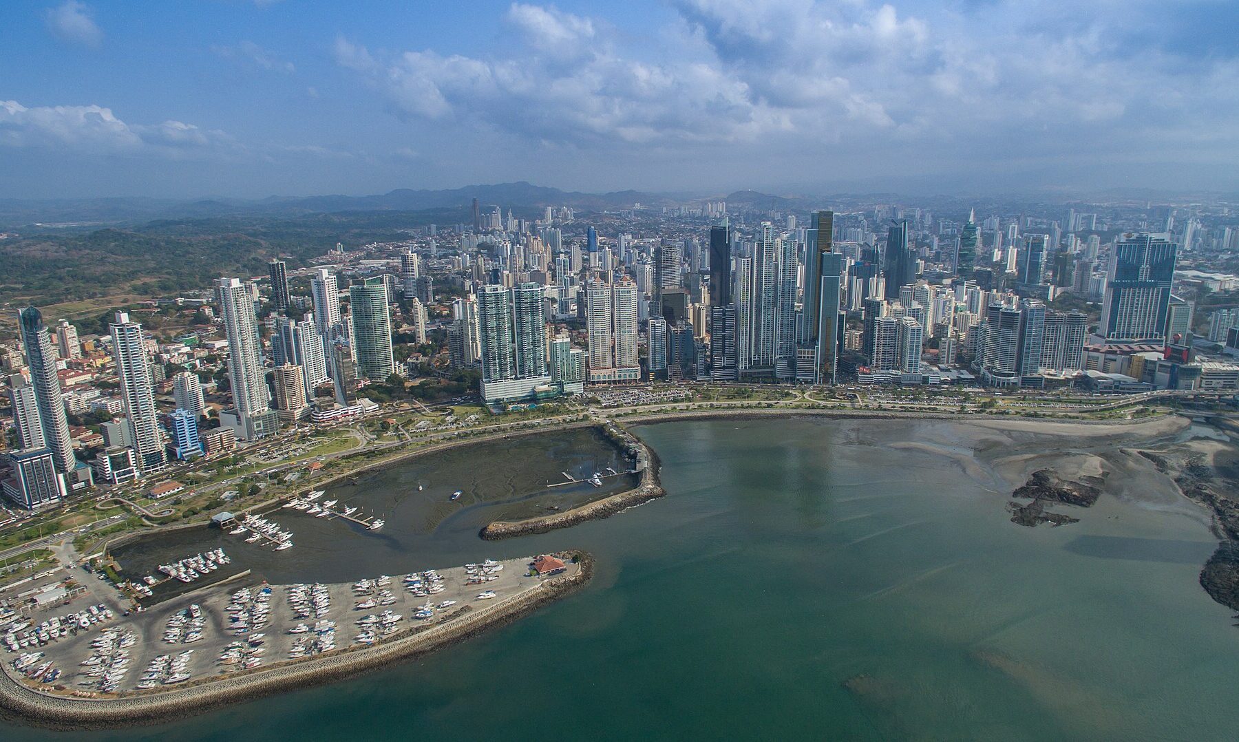 Aerial view of Panama City's financial district skyline with high-rise bank and office towers along the bay