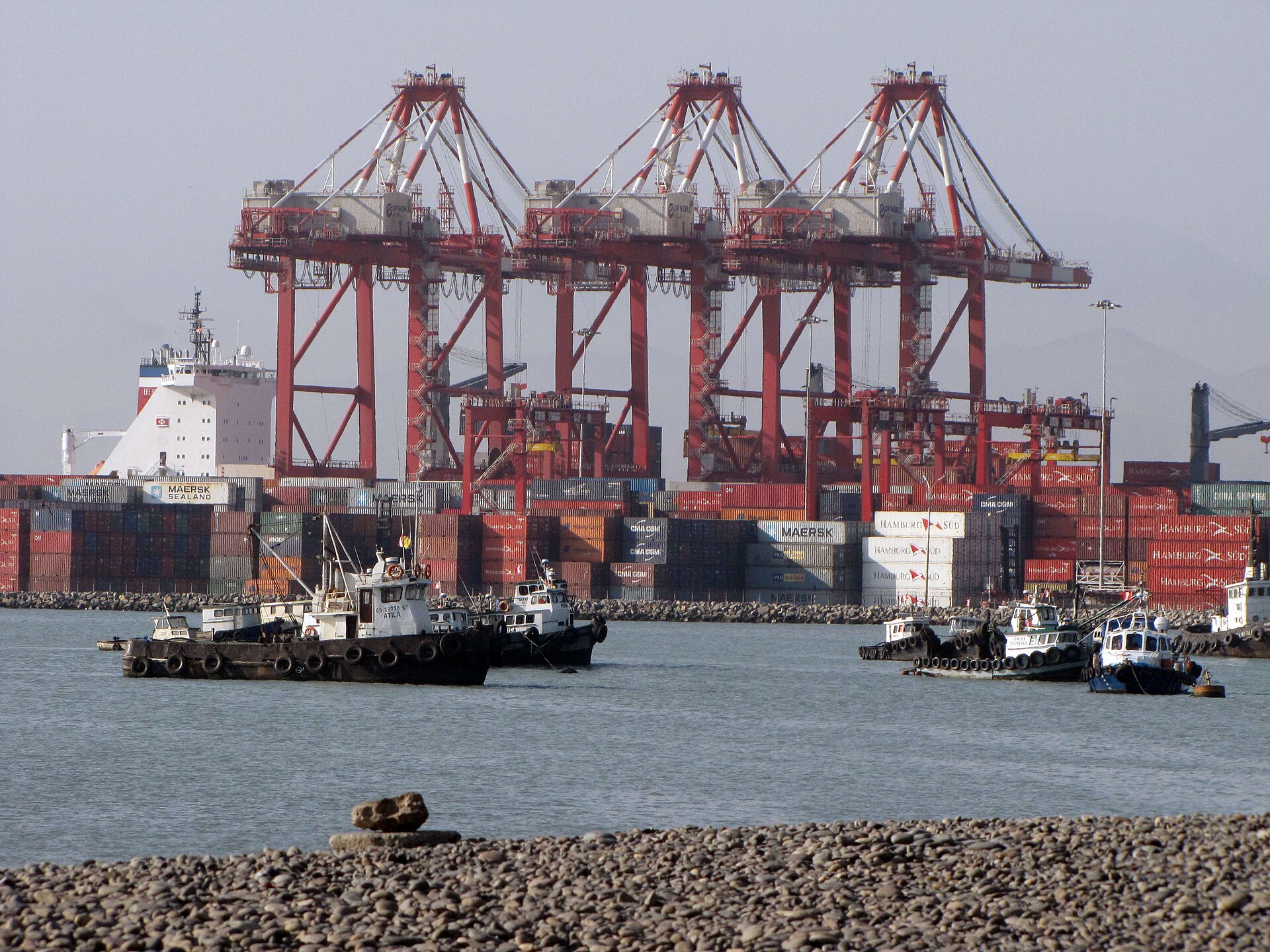 Gantry cranes and tugboats at Callao harbour in Peru