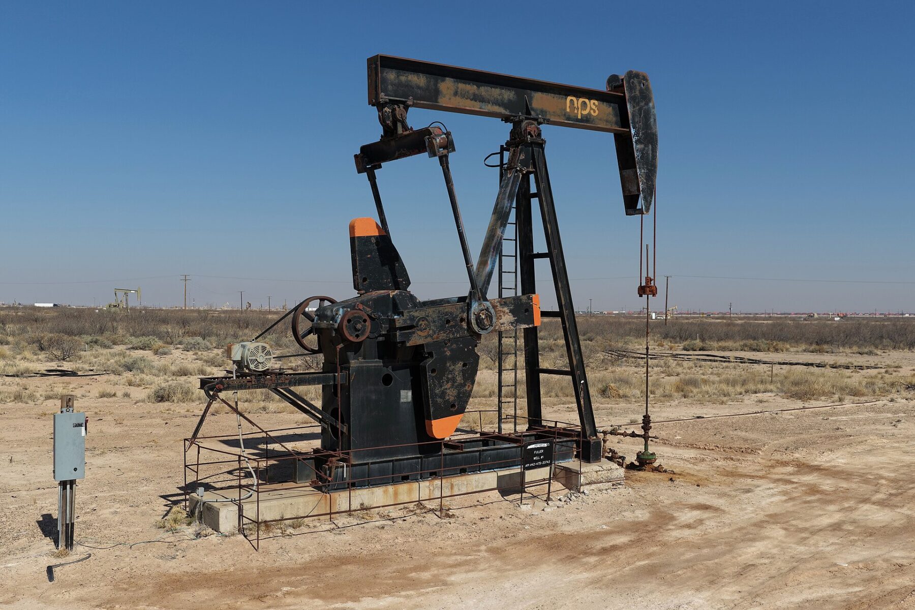 Oil pumpjack in the Permian Basin of West Texas under a clear blue sky