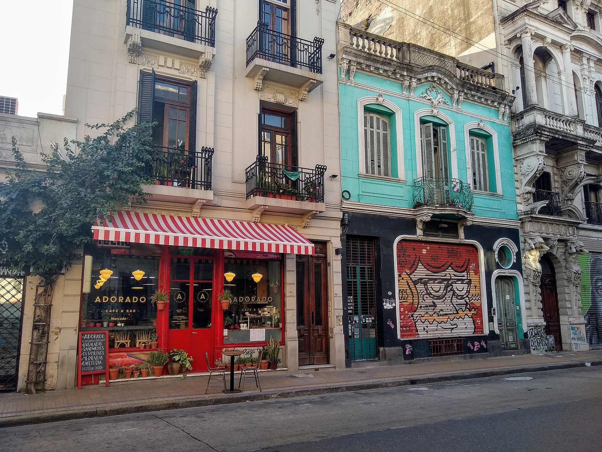Old townhouses and a corner cafe on a street in San Telmo, Buenos Aires, with flats above the shops