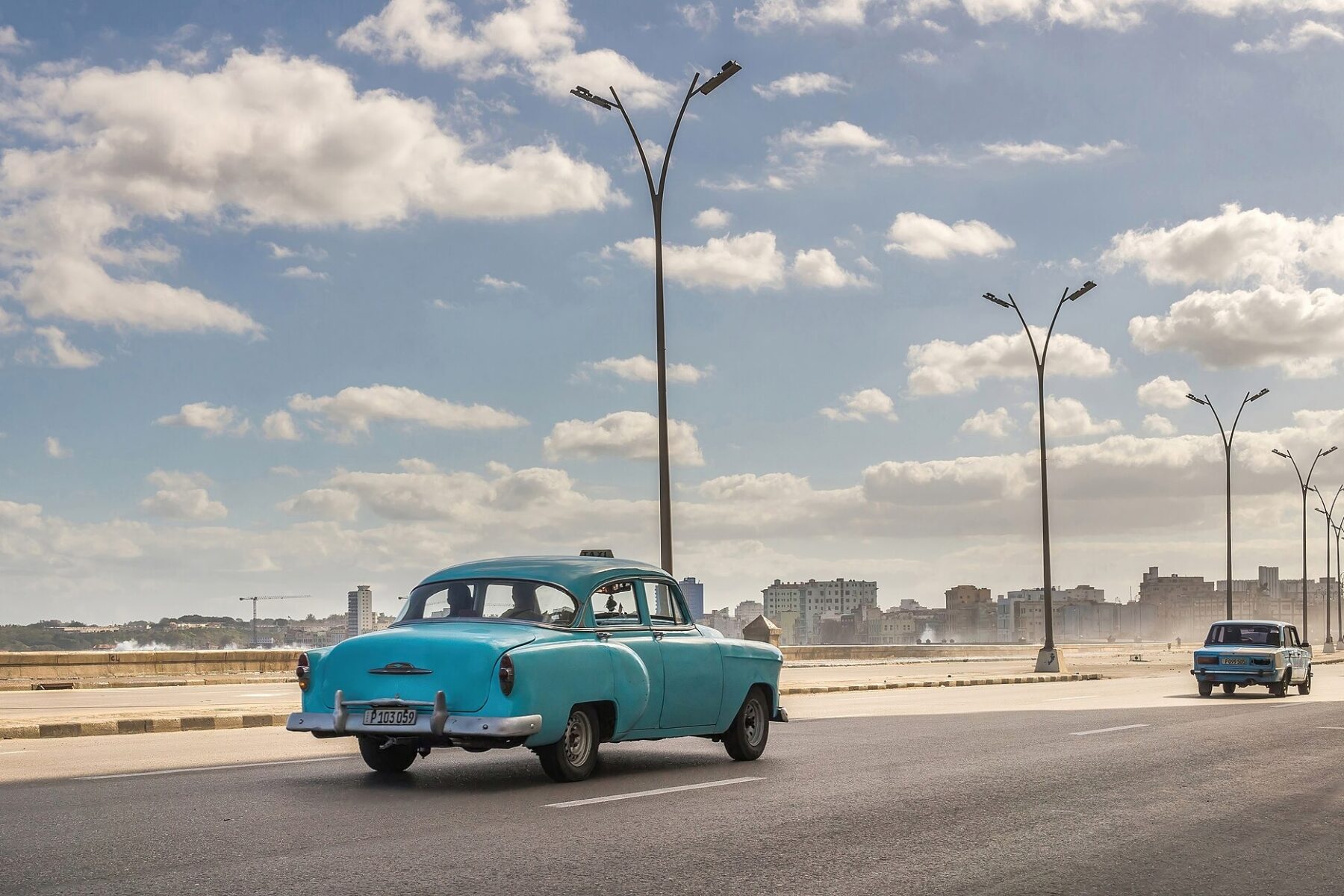 Cuba tourism - a vintage taxi on Havana's Malecón