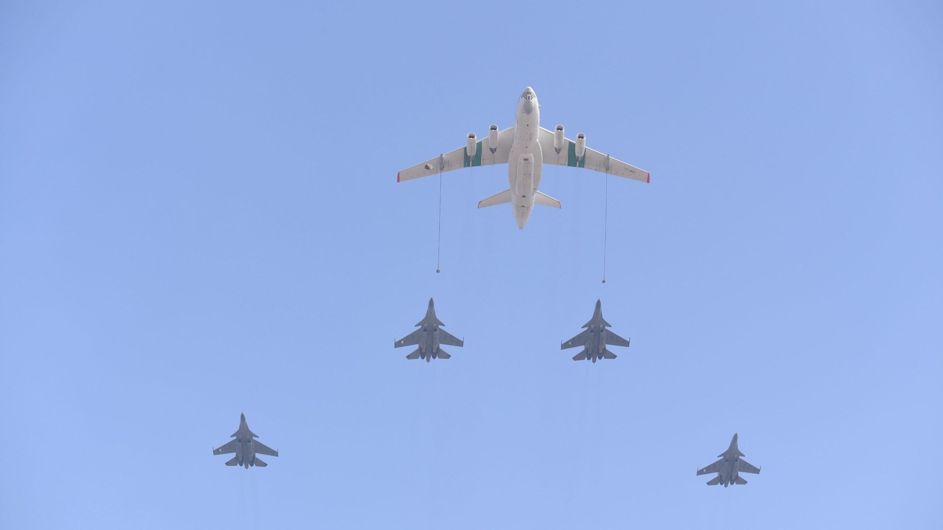 Algerian fighter jets parked on a tarmac in Niamey, with personnel and support vehicles nearby.