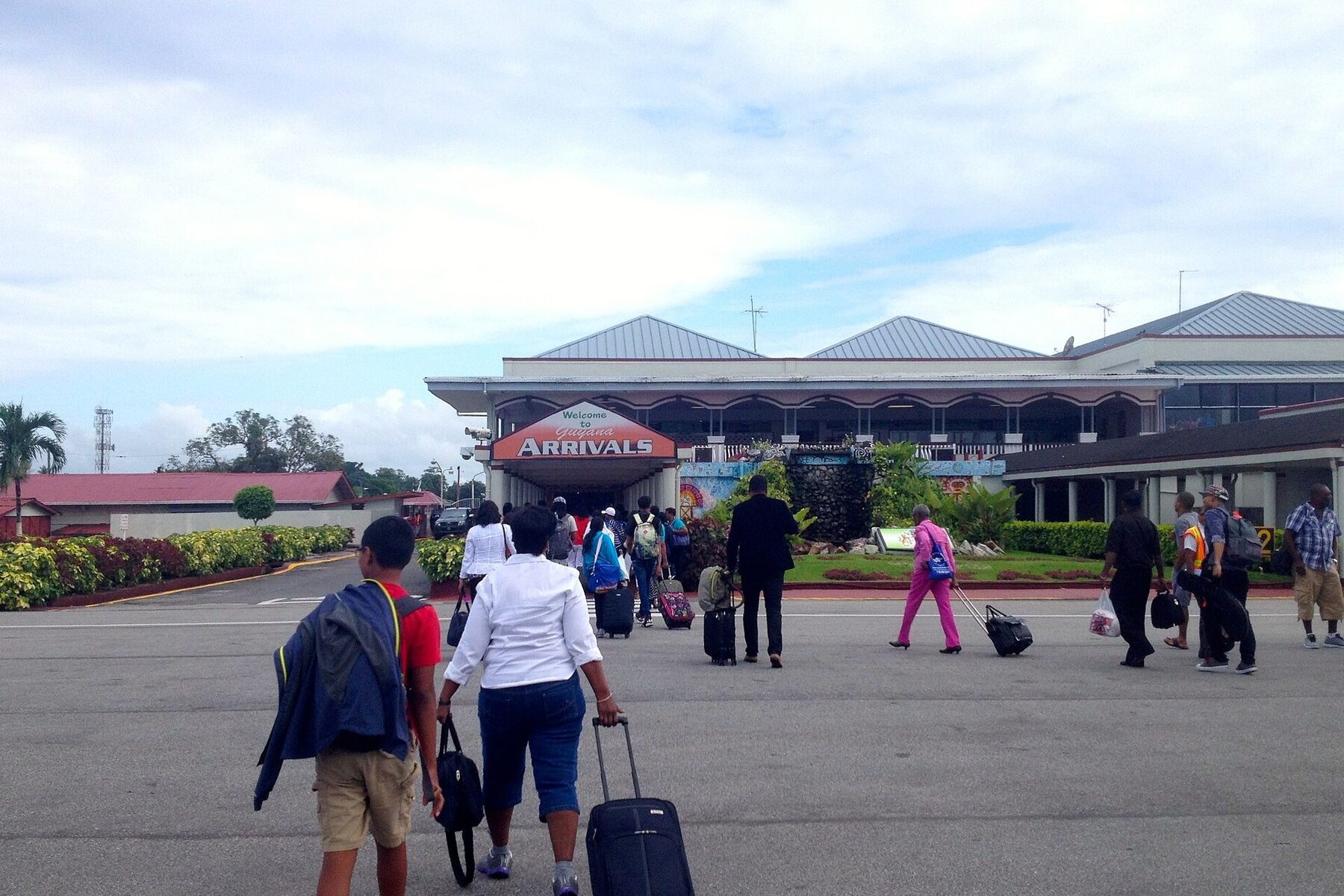 Travellers outside the arrivals hall at Cheddi Jagan International Airport, Guyana