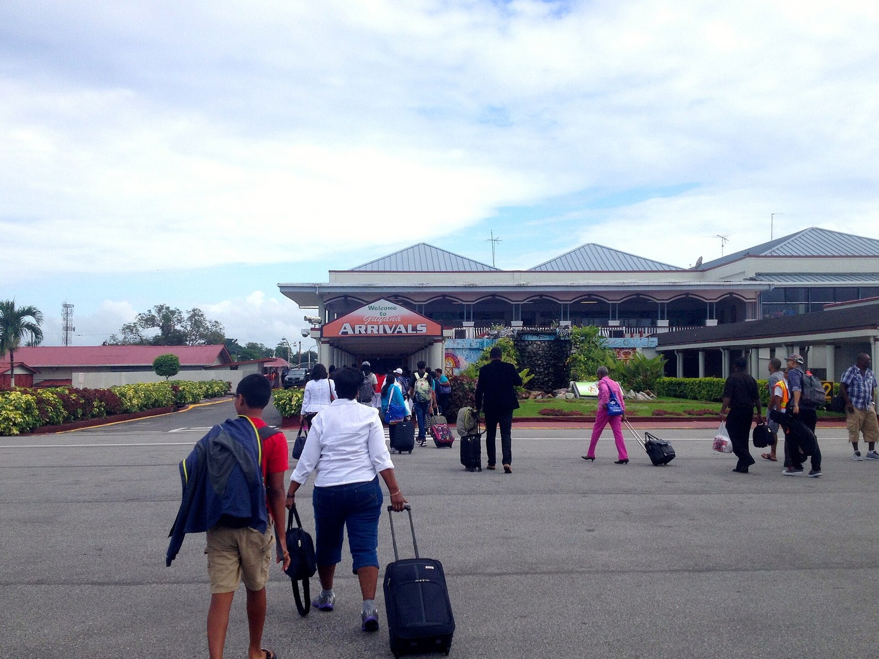Travellers outside the arrivals hall at Cheddi Jagan International Airport, Guyana