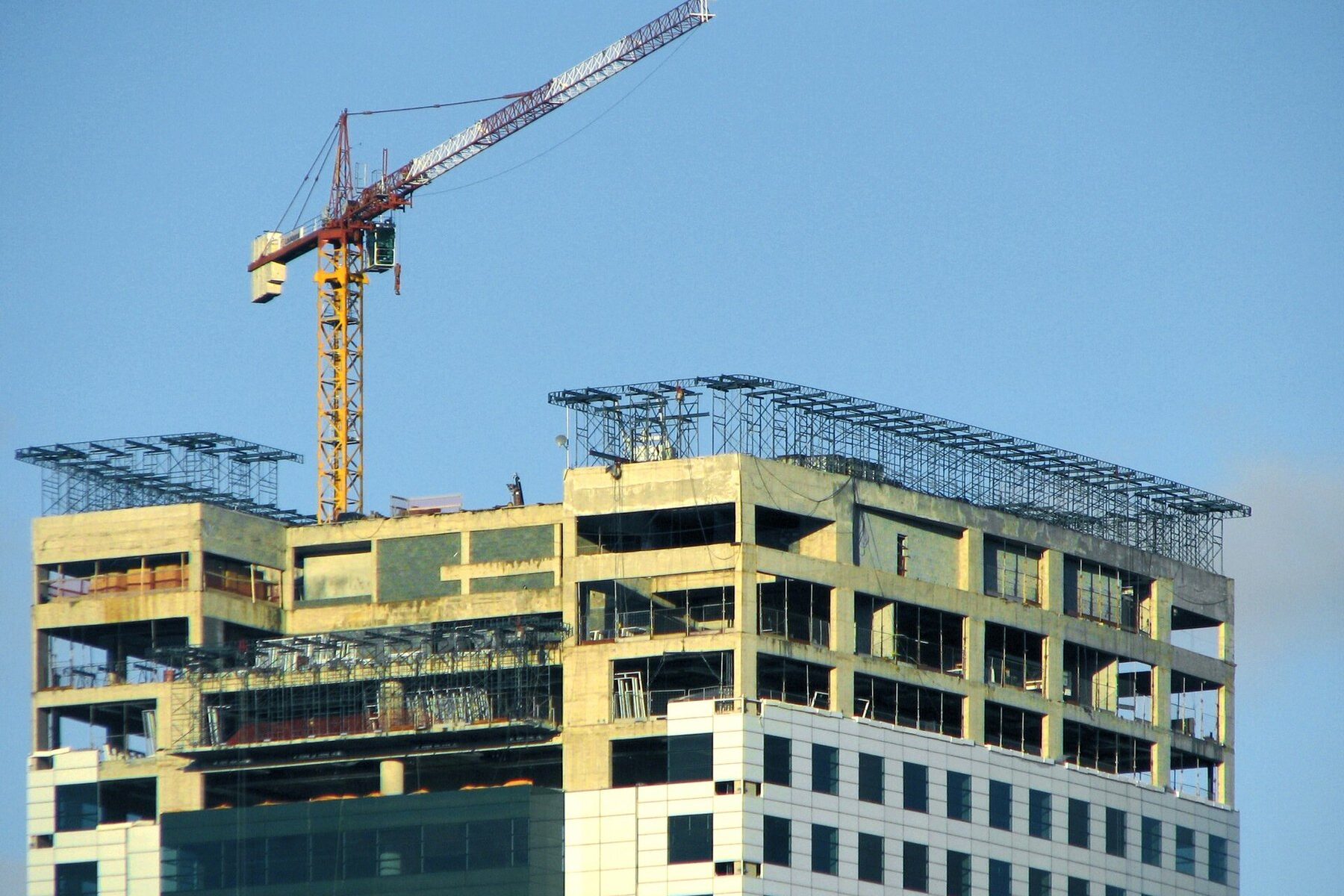A residential building under construction with a crane