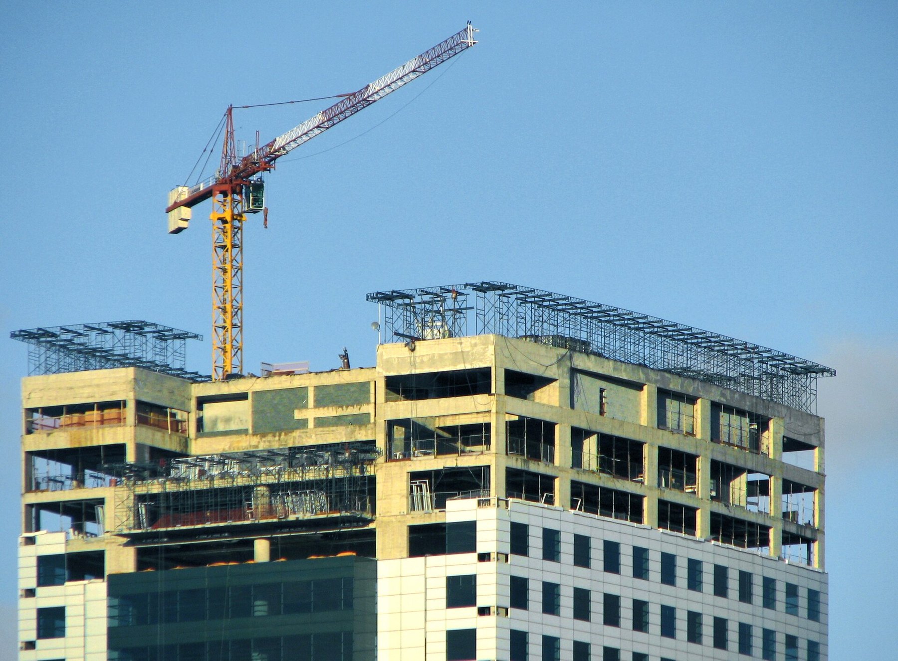 A residential building under construction with a crane