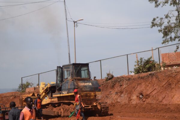 Road construction site in Rwanda with a Shantui bulldozer and workers
