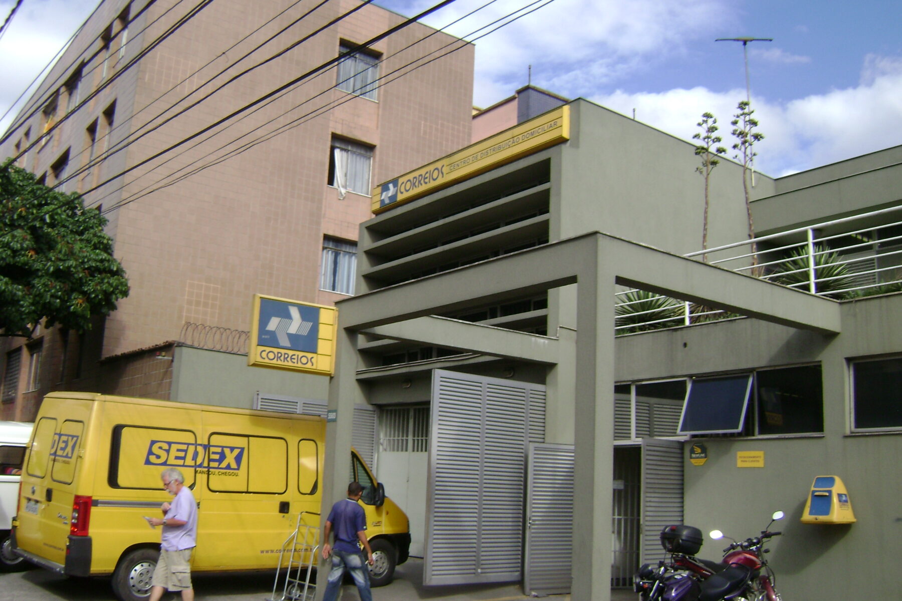 A Correios distribution centre in Belo Horizonte with a yellow Sedex delivery van