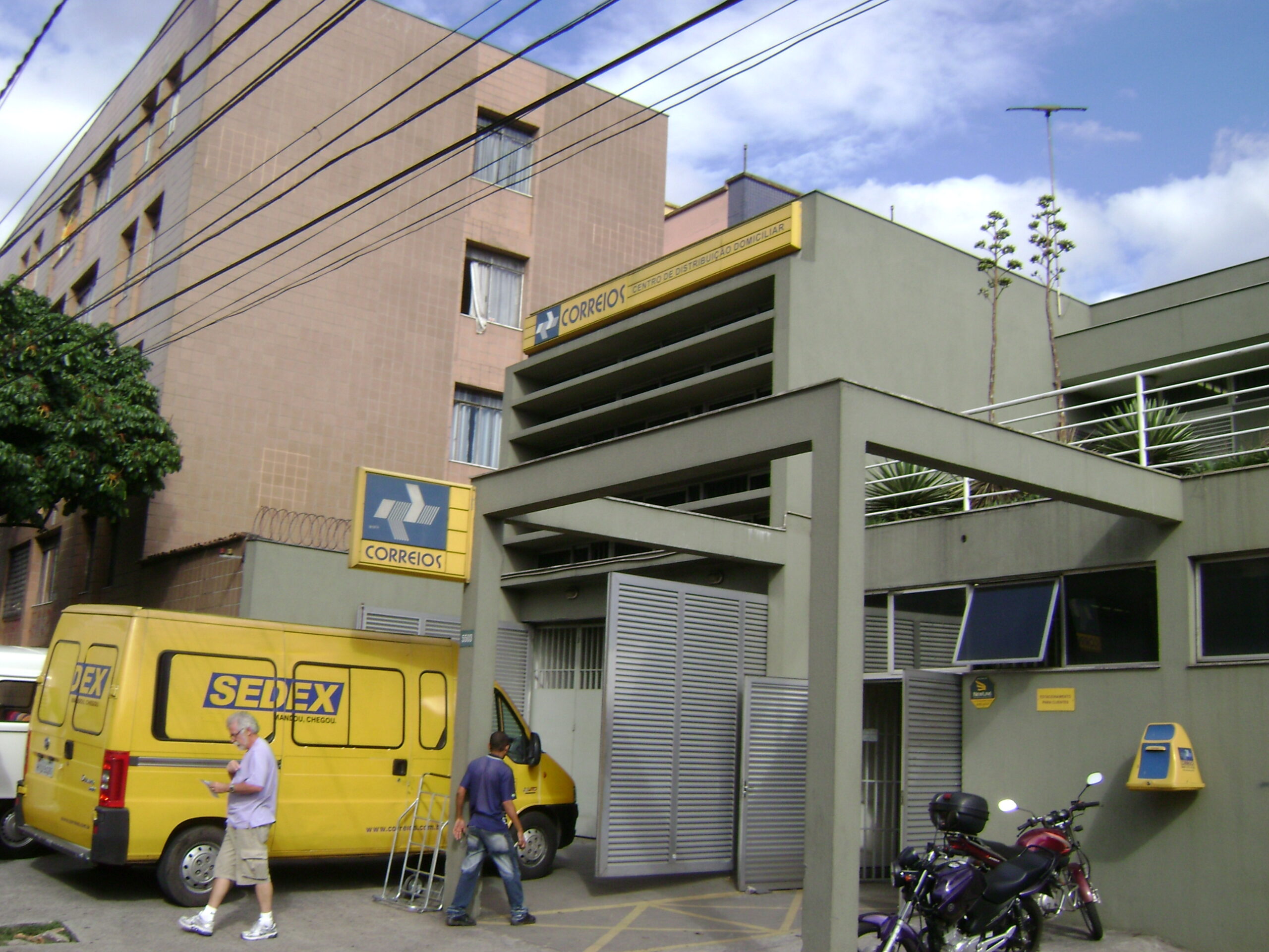 A Correios distribution centre in Belo Horizonte with a yellow Sedex delivery van