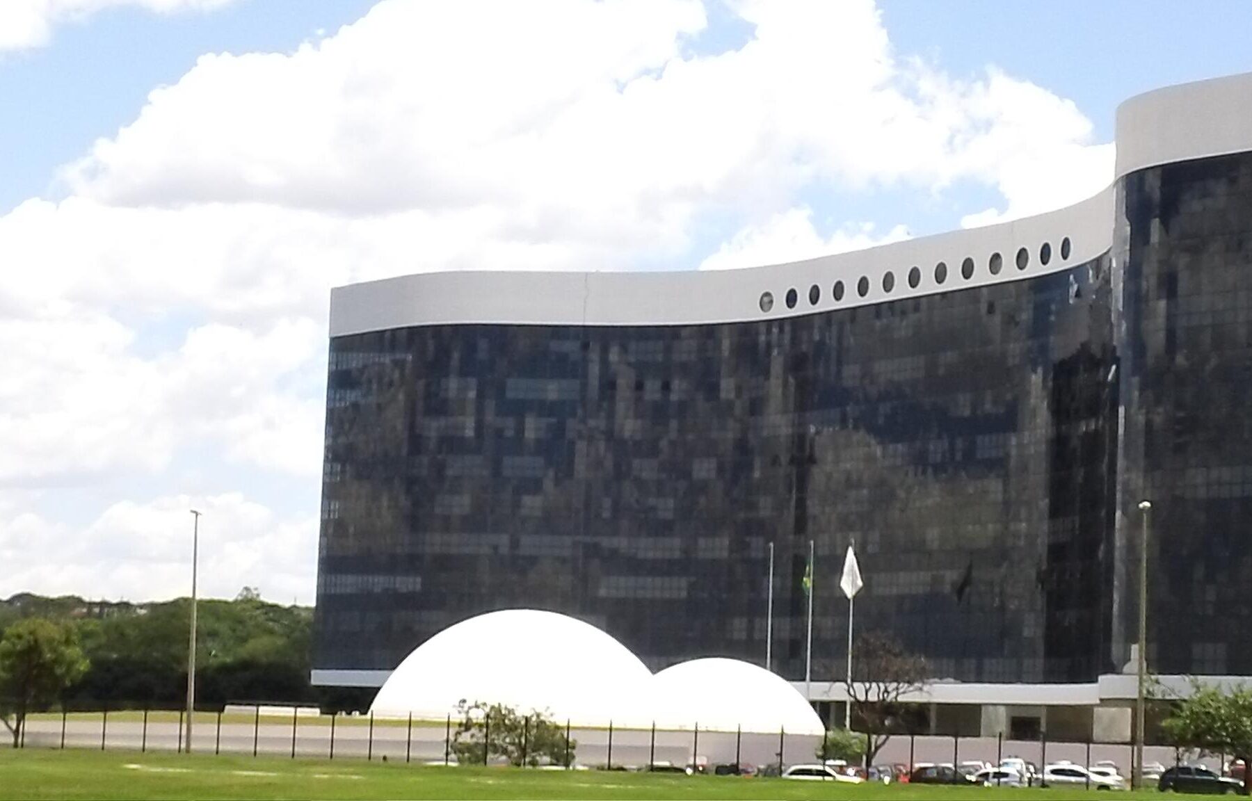 Modern building with glass facade and white curved roof
