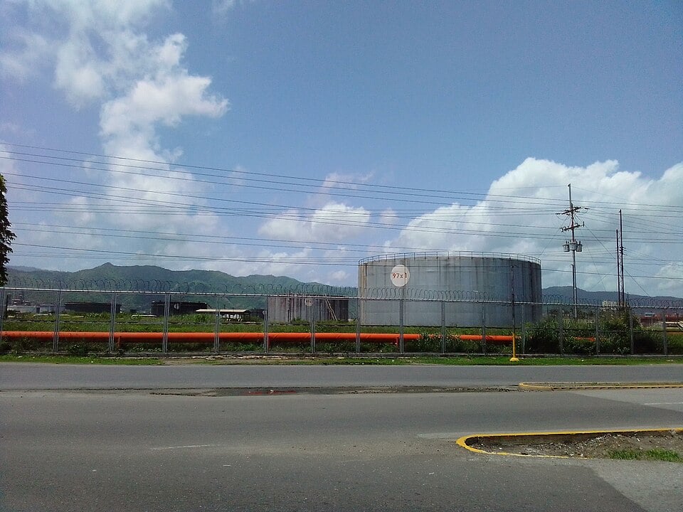 A storage tank at the Puerto La Cruz refinery in Venezuela behind a security fence