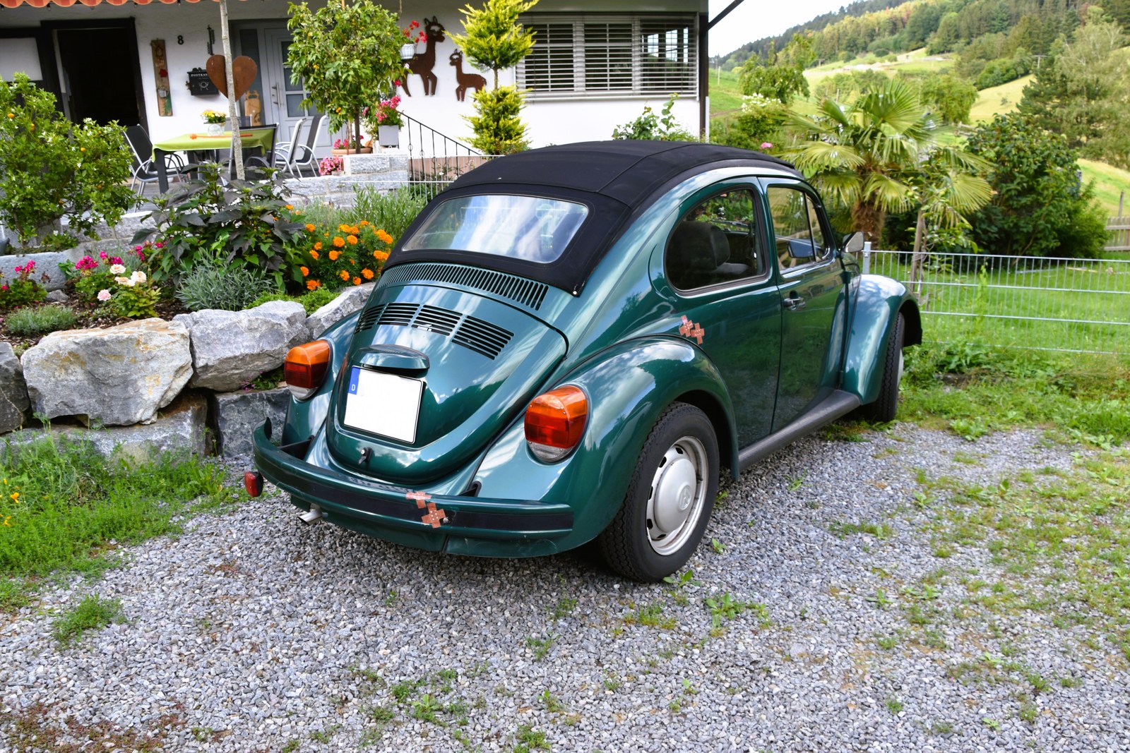 A late-model Mexican-built Volkswagen Beetle 1600i with an open roof; the Volkswagen Puebla layoffs now hang over the plant that built it