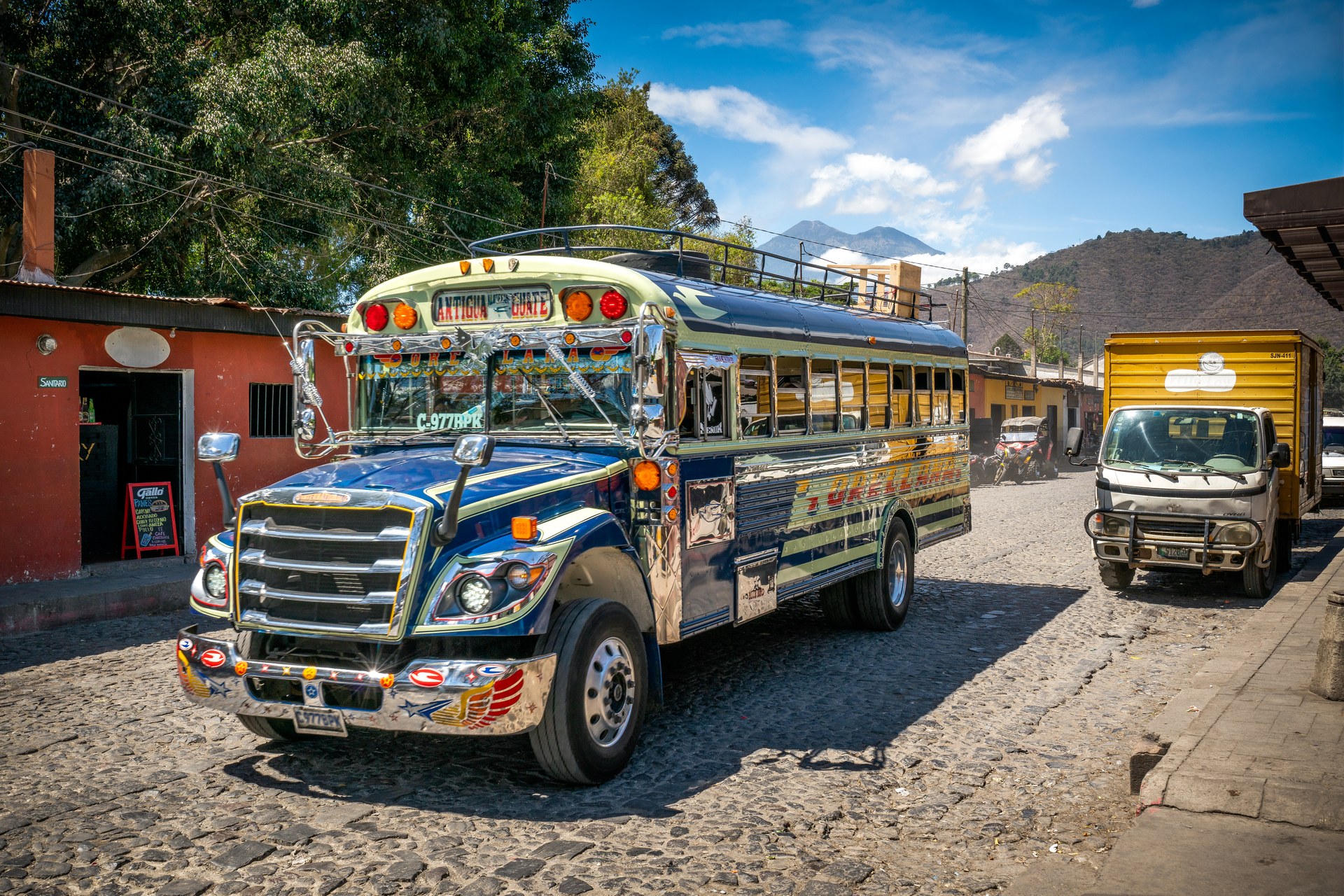 Guatemala fuel protests — a public bus and a cargo truck in Antigua Guatemala, the transport sector hit by the 37 percent fuel price surge