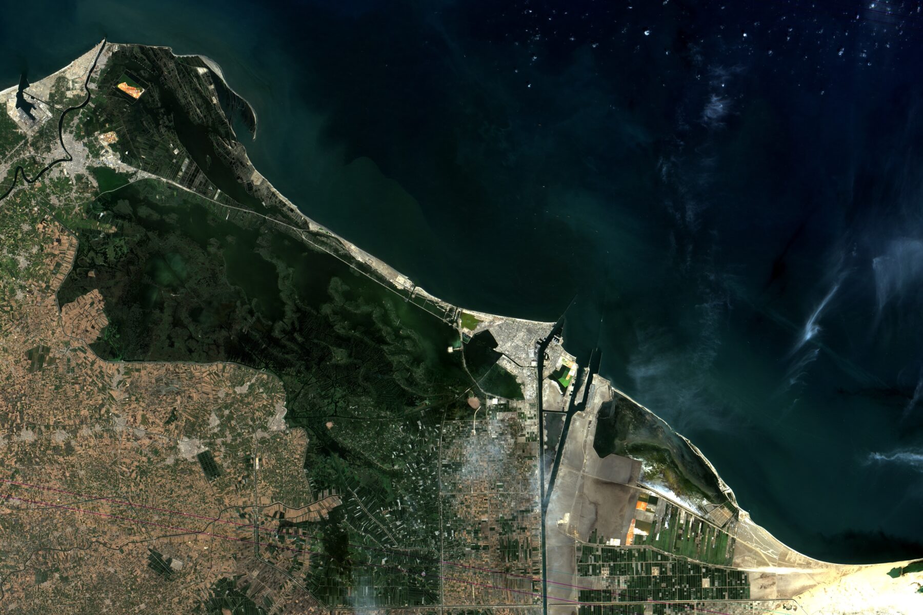 Satellite view of the Suez Canal's Mediterranean entrance at Port Said, Egypt, with ships approaching the channel