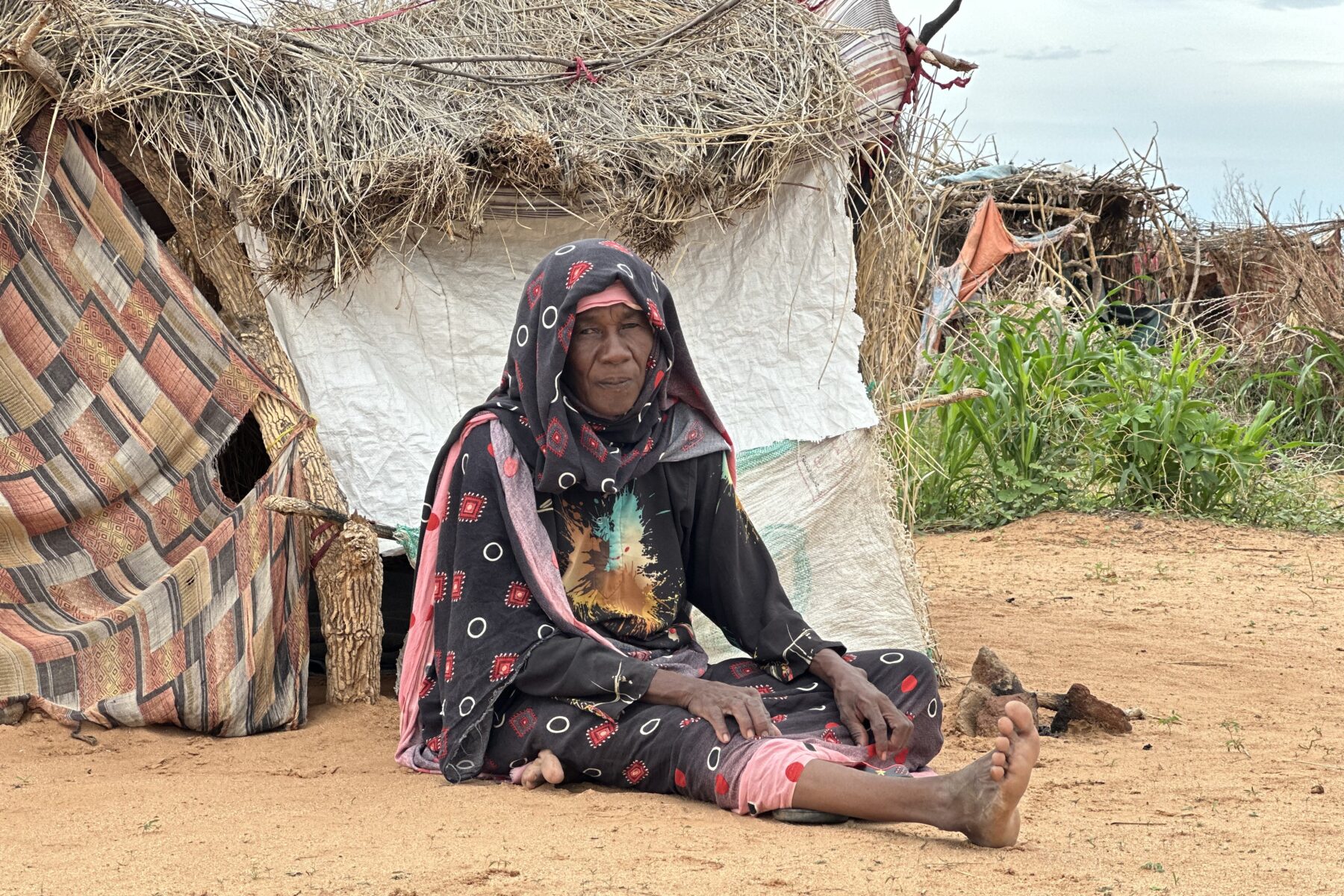 A displaced woman from El Fasher at a makeshift shelter in Tawila, North Darfur