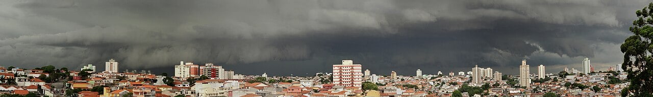 A dark storm front rolling over the skyline of São Paulo