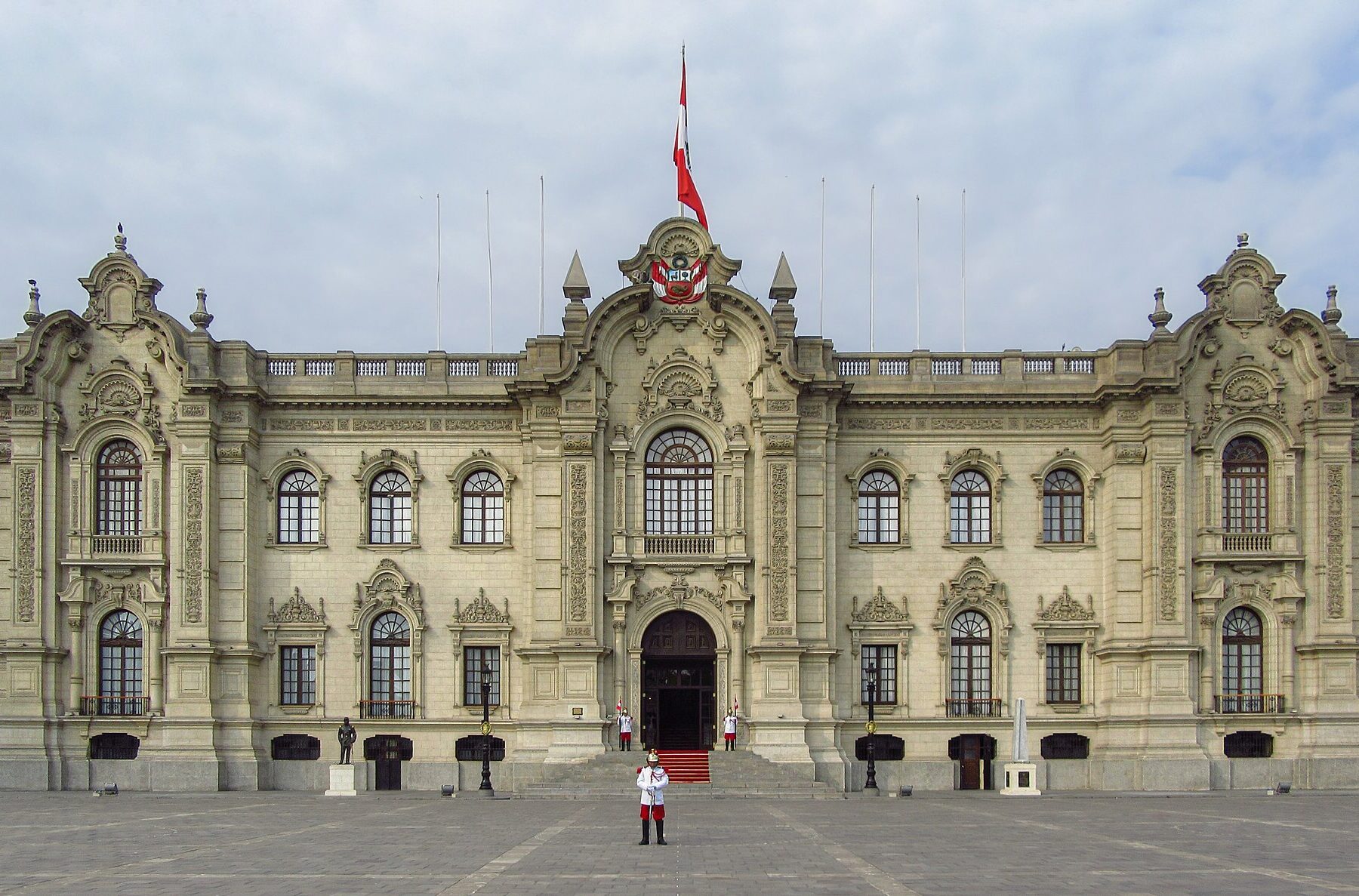 Facade of Peru's Government Palace in Lima with a guard in ceremonial uniform