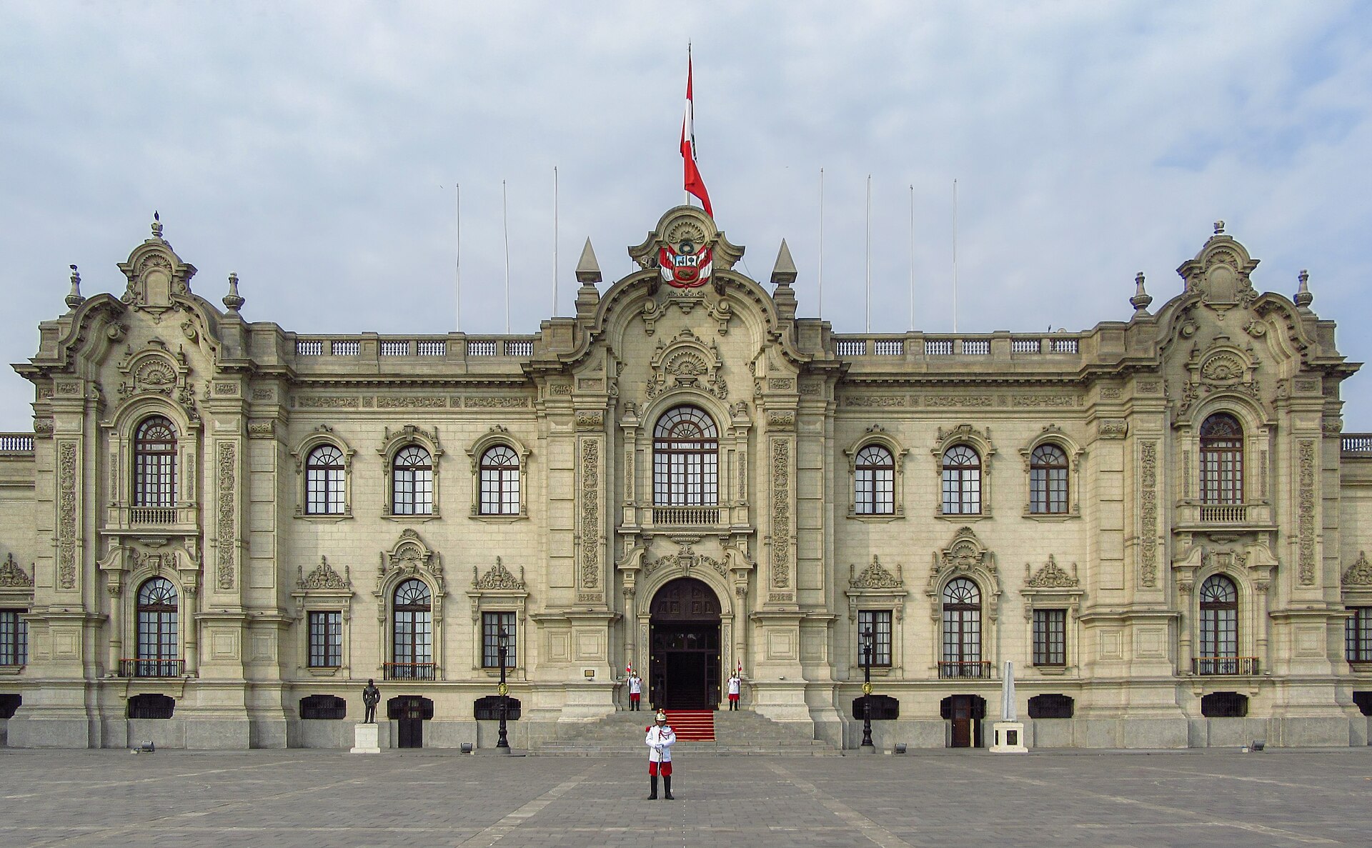 Facade of Peru's Government Palace in Lima with a guard in ceremonial uniform