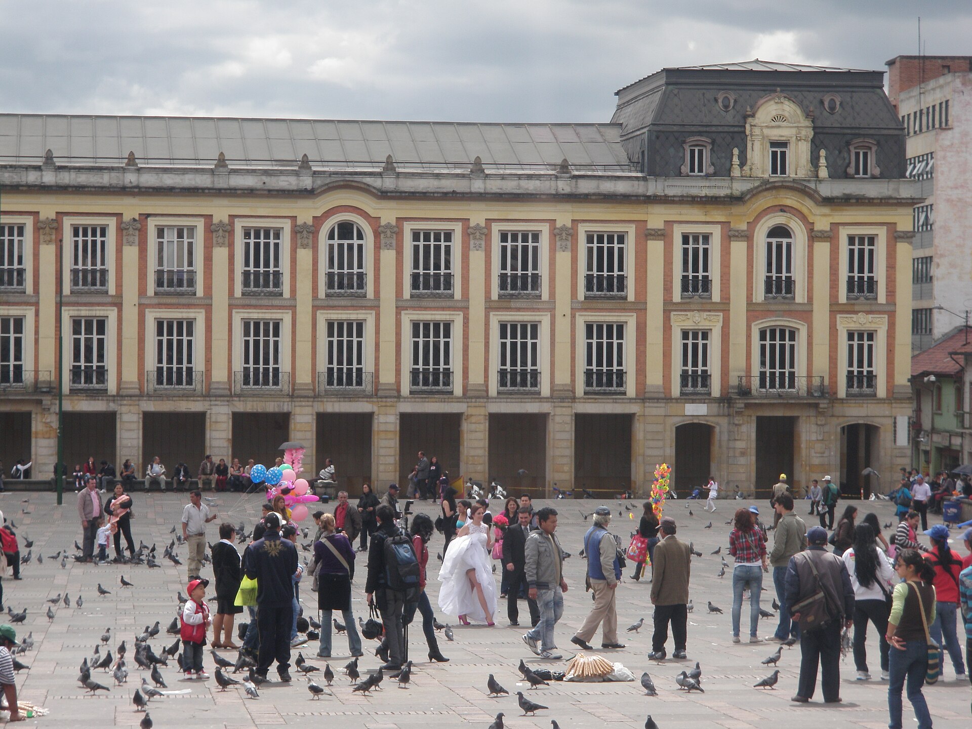 Palacio Liévano, seat of Bogotá’s mayor’s office, seen across Plaza de Bolívar with people and pigeons