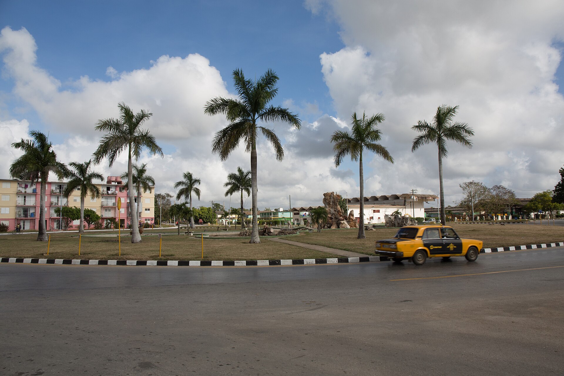 Street with palm trees and apartment blocks in the city of Ciego de Ávila, Cuba