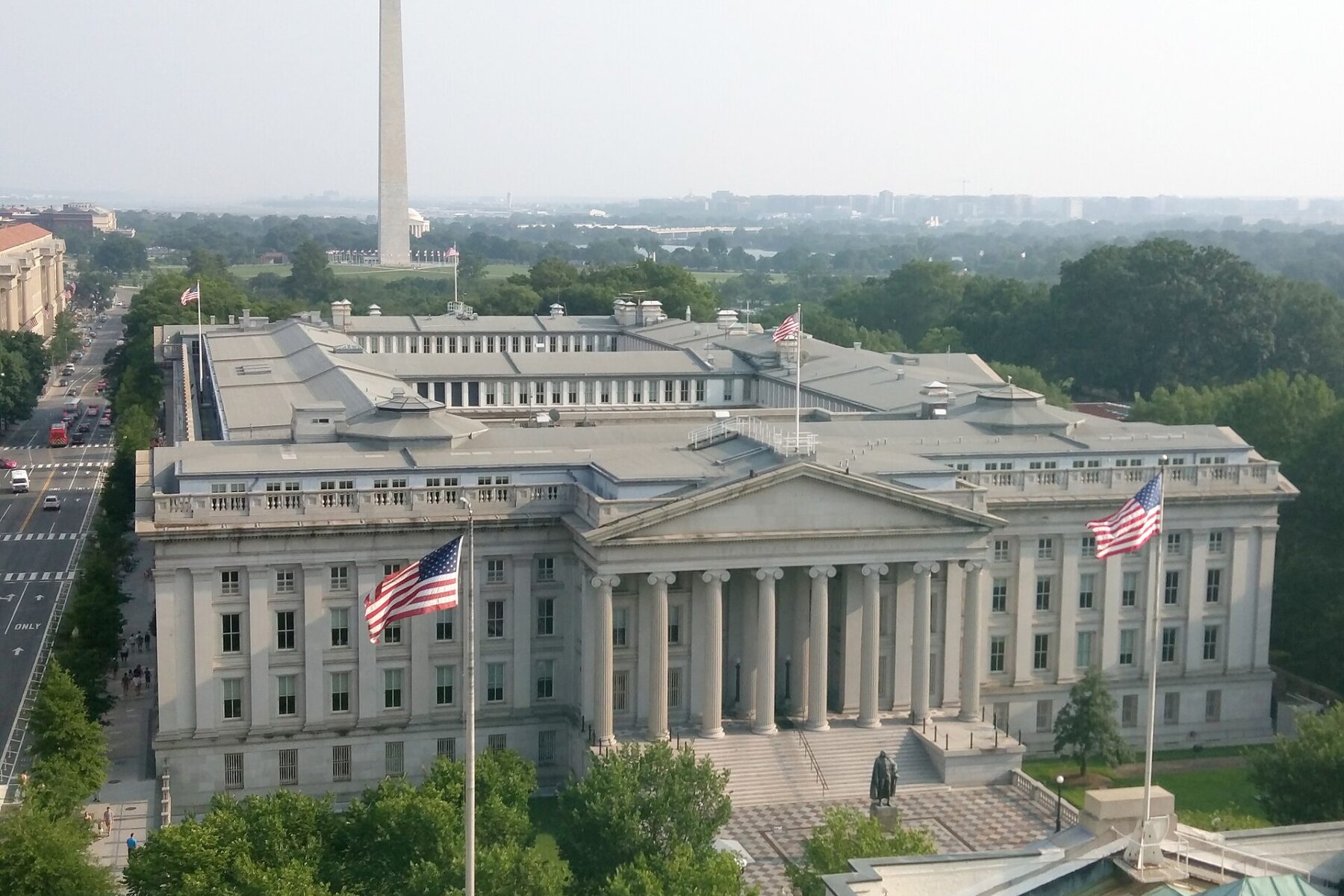 The US Treasury Building in Washington with the Washington Monument behind it