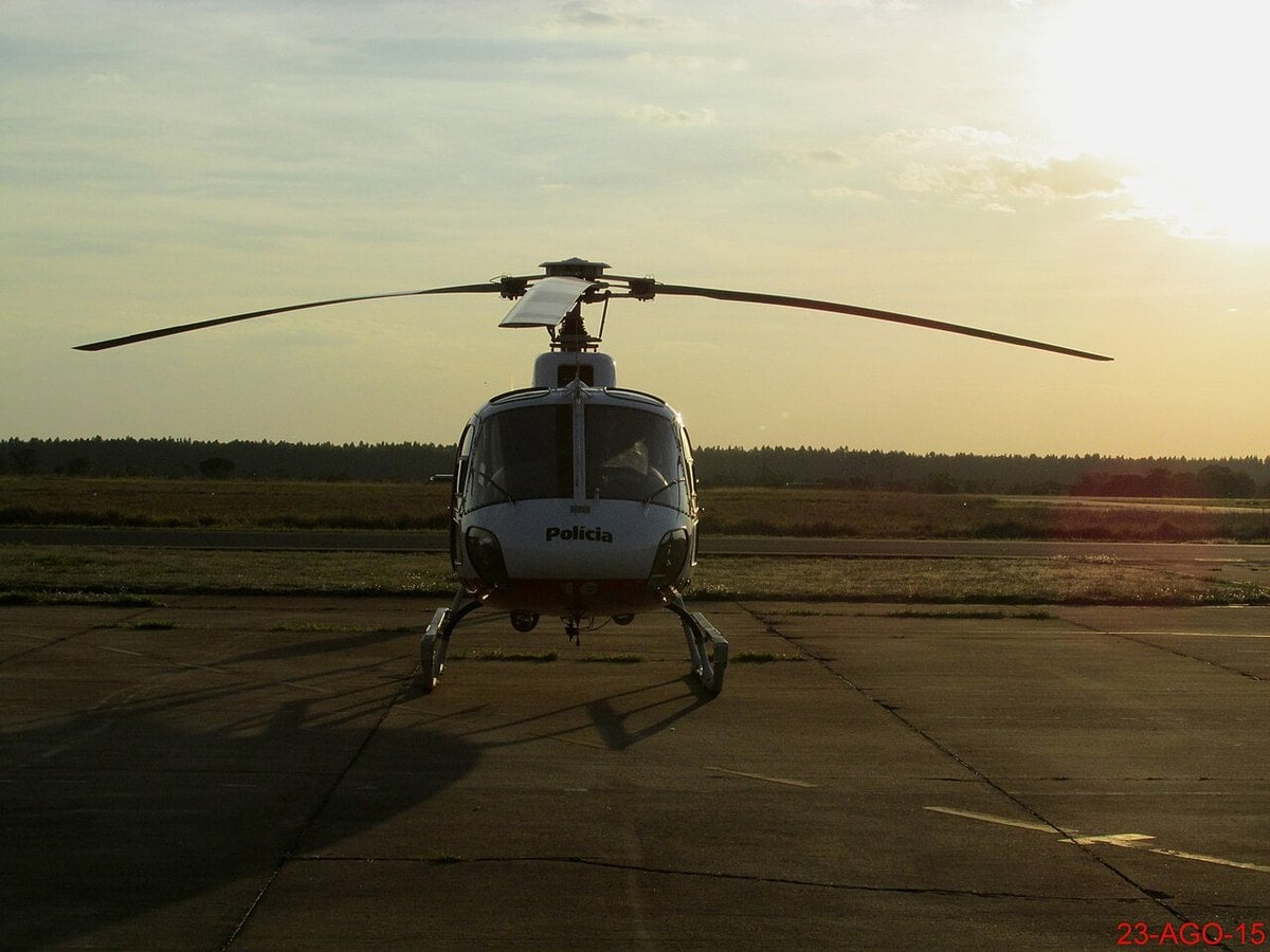 A São Paulo Military Police helicopter on a runway at dusk