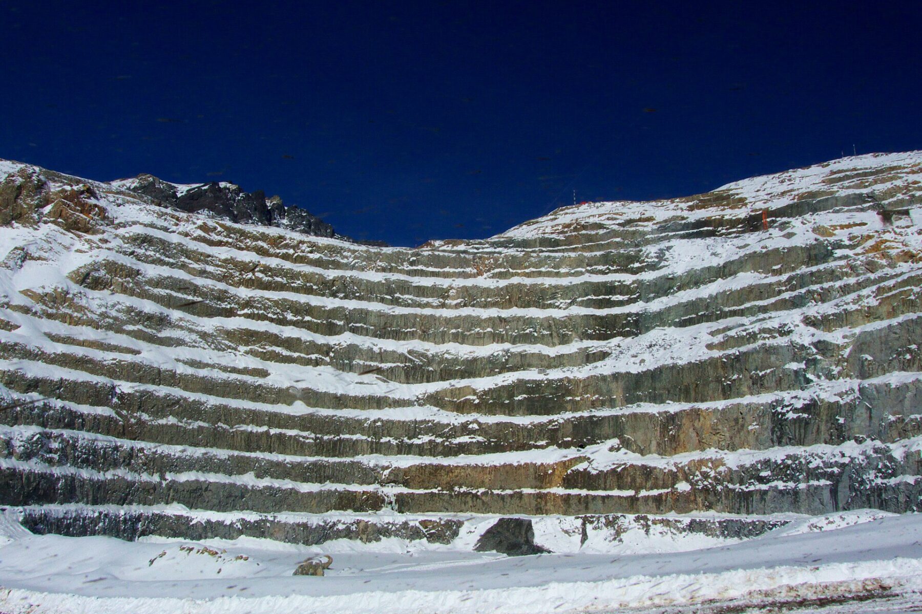 Terraced benches of Codelco’s Andina copper mine in Chile under snow