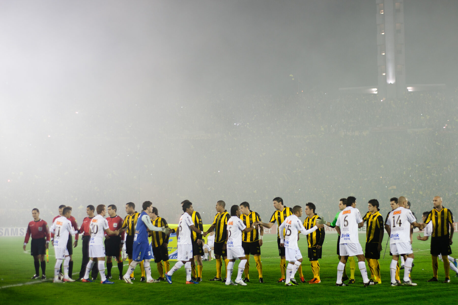 Penarol and Santos players shake hands before a Copa Libertadores match