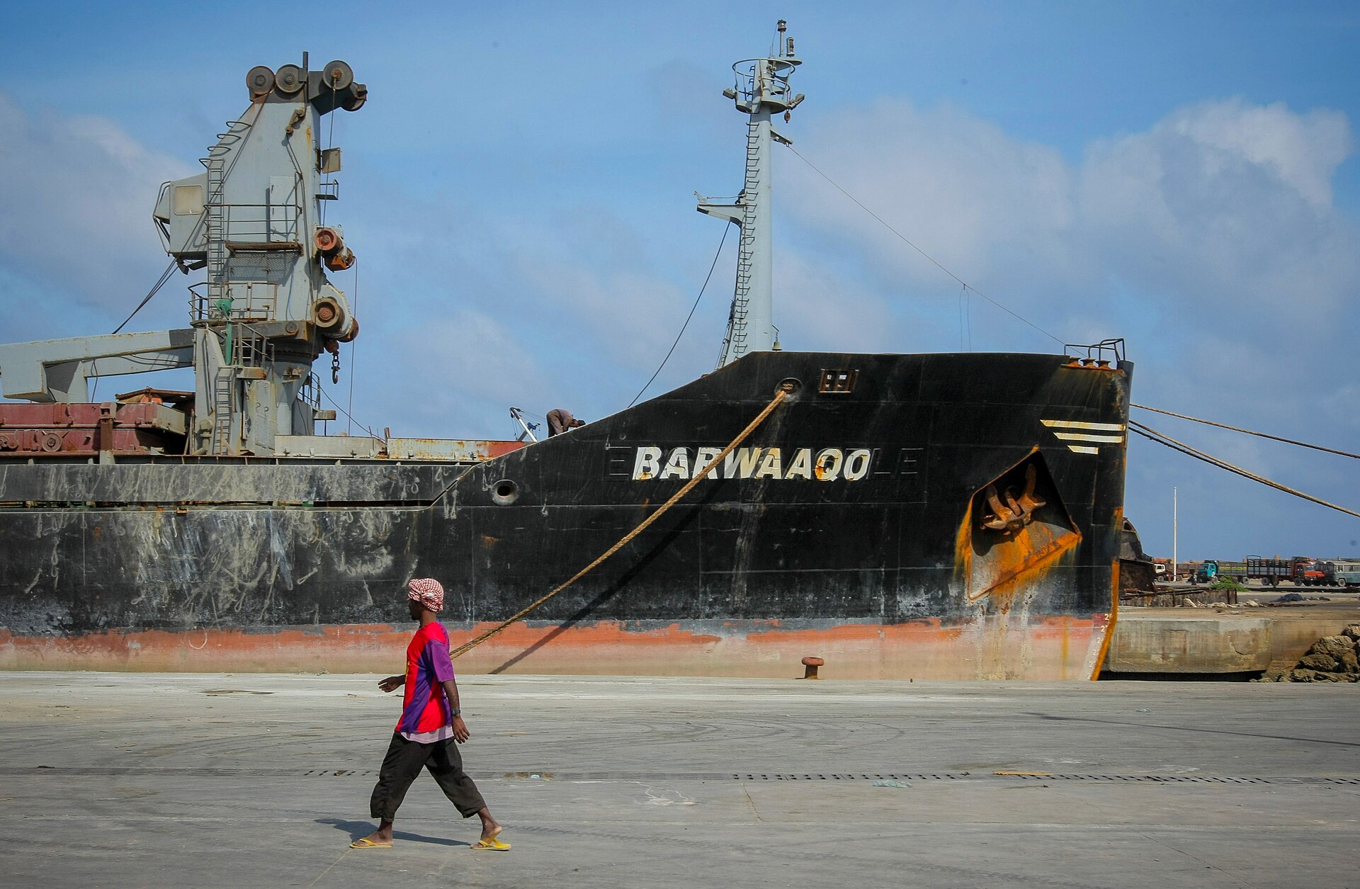 Somalia explained: a dock worker walks past a ship in the seaport of Mogadishu