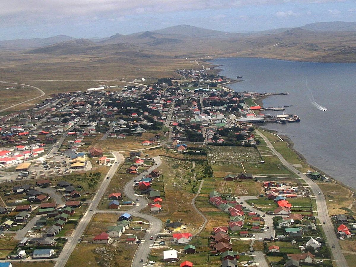 Aerial view of Stanley in the Falkland Islands, with the harbour on the right and the settlement spread along the shore
