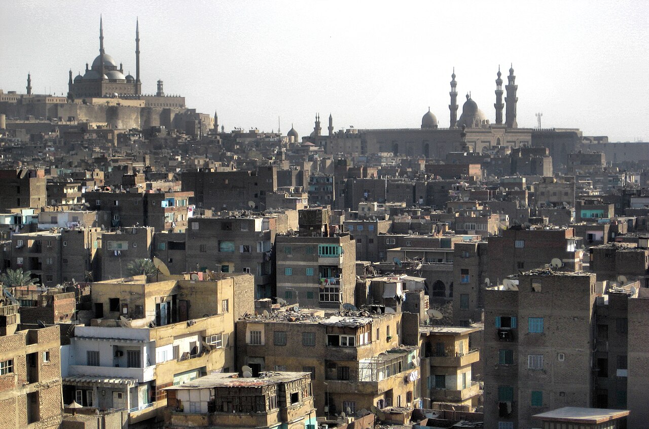 The rooftops of historic Cairo with the Citadel and the Sultan Hassan mosque on the skyline